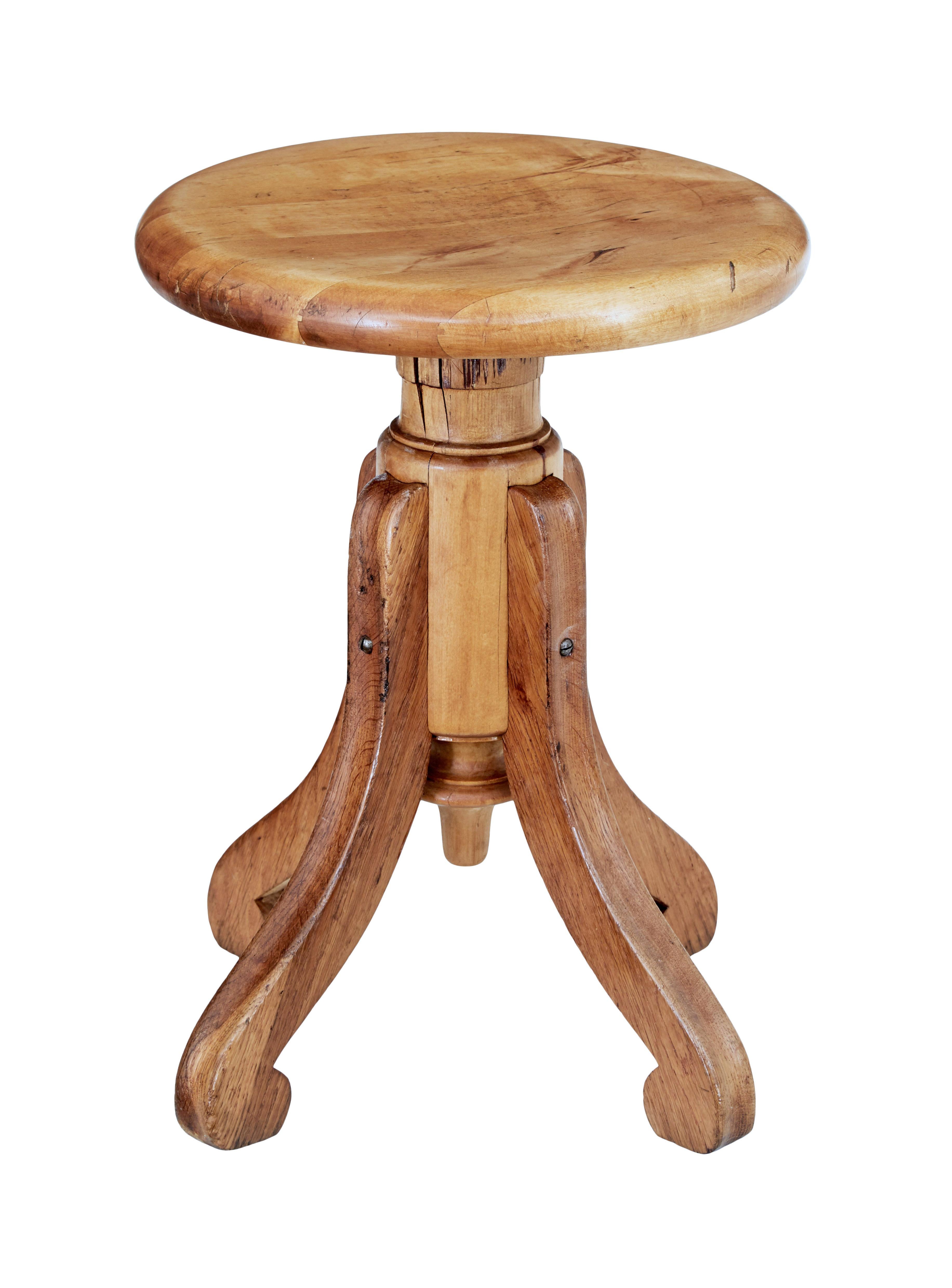 Late 19th century oak and pine piano stool, circa 1890.

Good quality stool with plenty of character. Shaped circular seat connected to a thread which allows a 4 inch variation in height. Supported by 4 scrolled legs.

Could lend itself