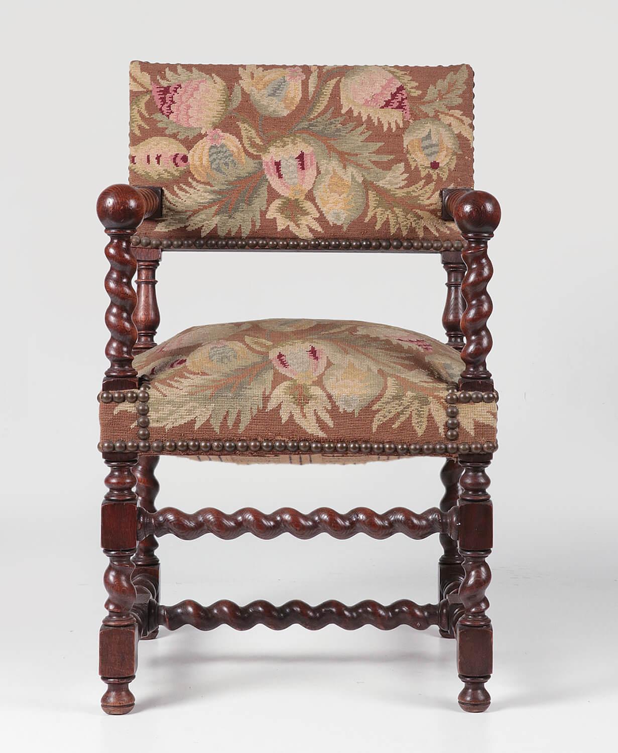Beautiful antique oak chair with twisted elements and a woolen petit point upholstery. The wood has a beautiful vivid patina. The upholstery is completely fine. The chair is sturdy and robust.
