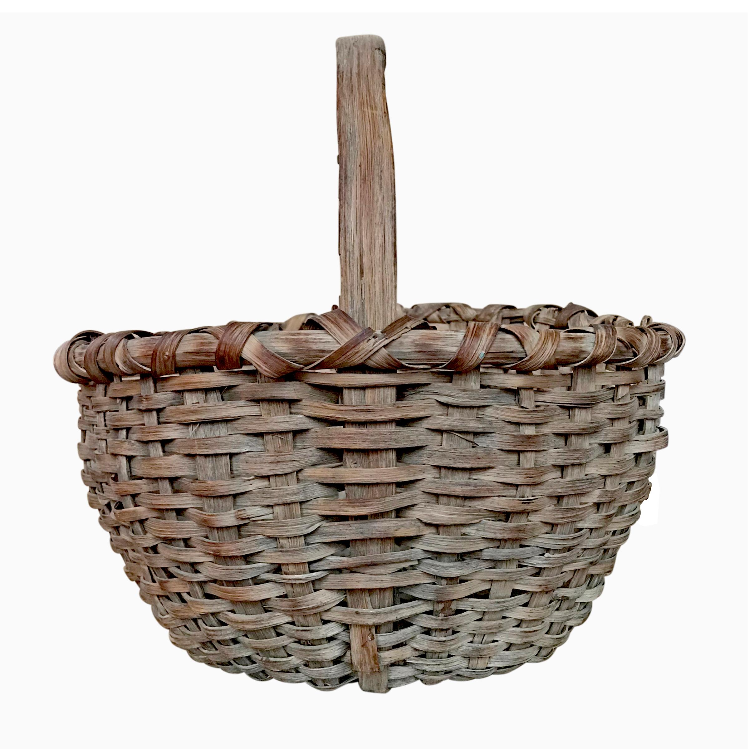 A late 19th century American handwoven oak splint gathering basket with a single bentwood handle, thin splints, and a wonderful patina. Found in Connecticut.