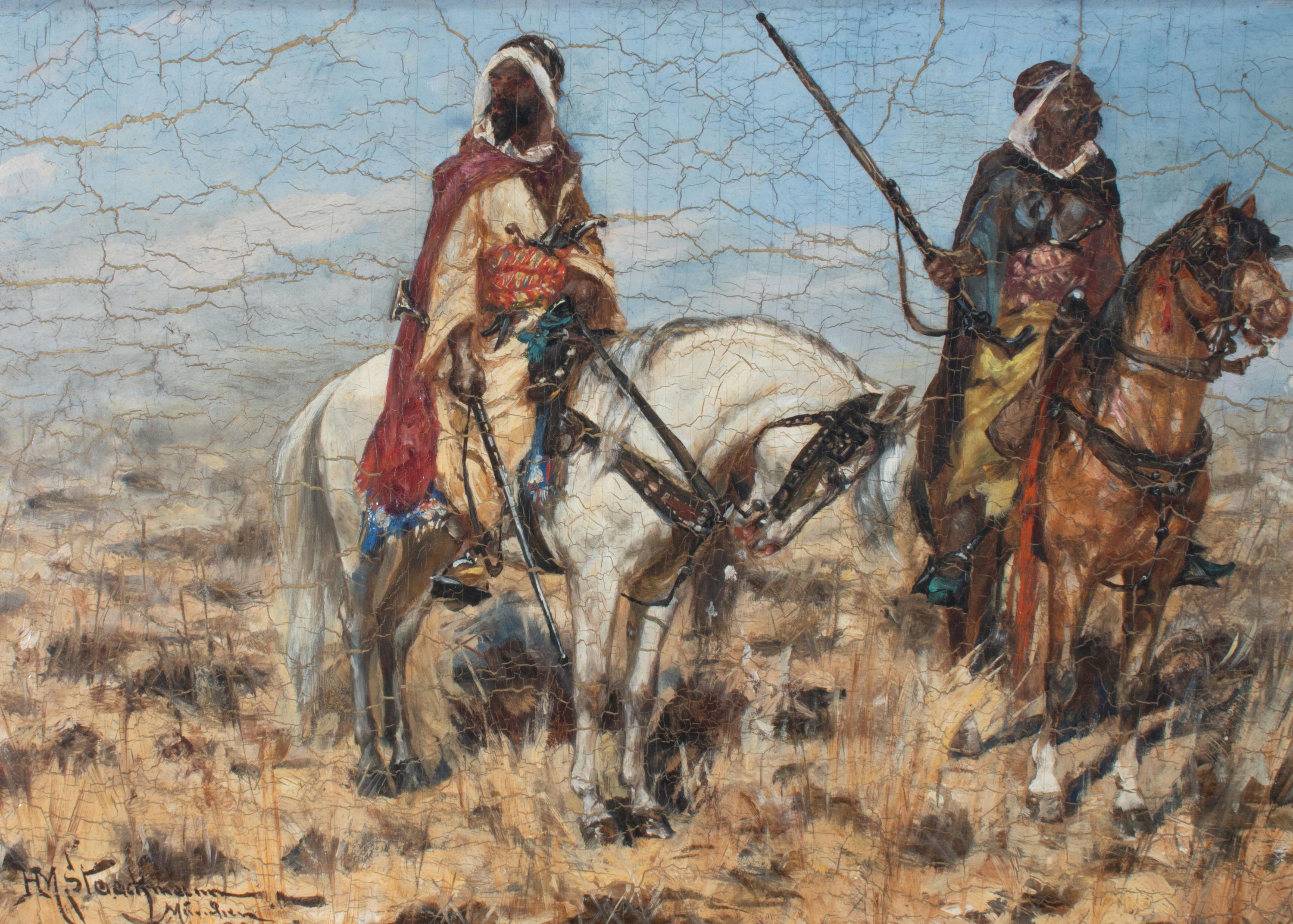 This late nineteenth-century oil-on-mahogany board by German painter Heinrich Maria Staakmann (1852-1940) depicts two Bedouin men suited for combat on horseback against a trampled desert landscape. Housed in a double motif giltwood frame, with the