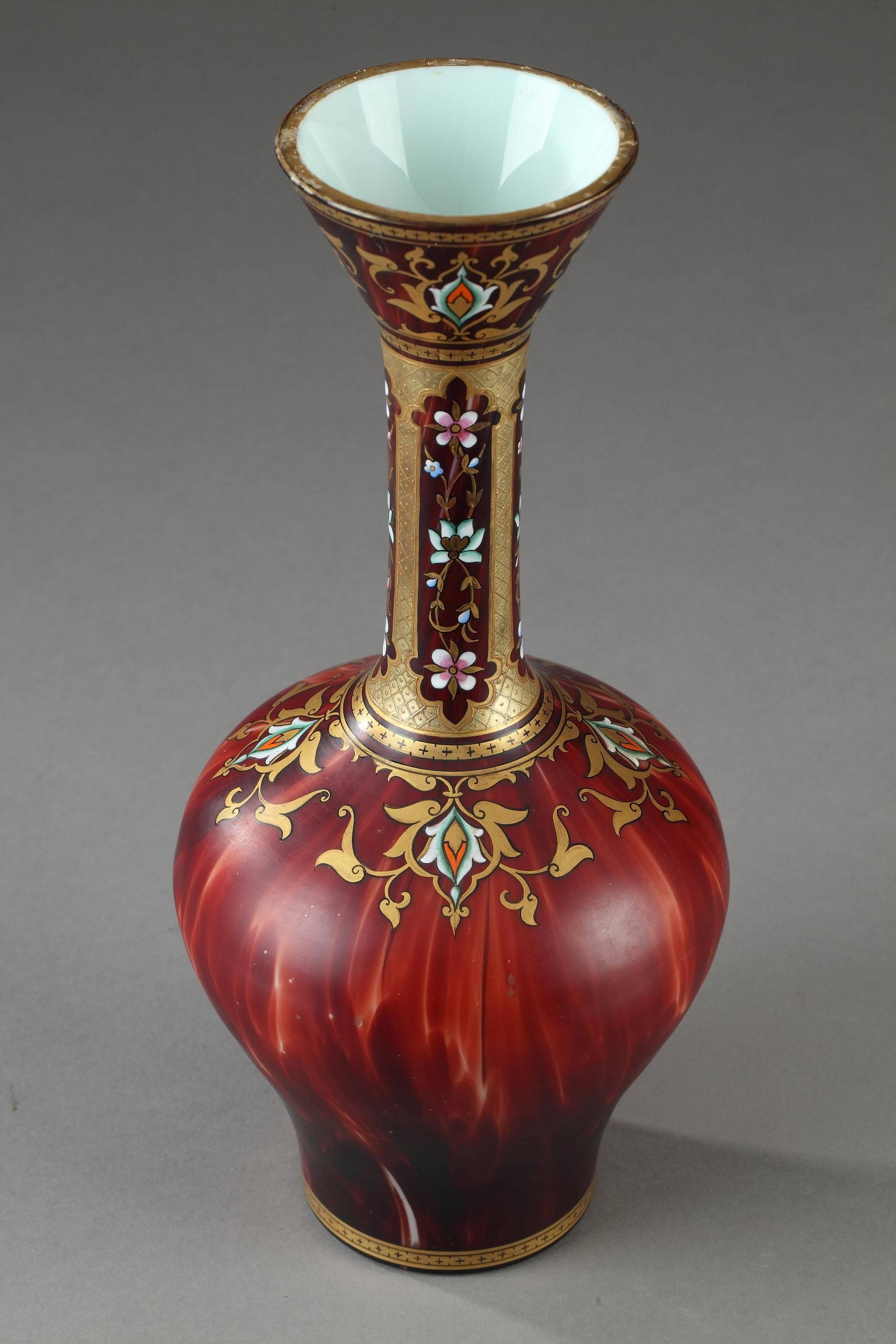 Bulb-bottomed vase with long neck decorated with multicolored enamel and gold. It is embellished with arabesques, flowers and latticework patterns in orientalist taste on a marbled Bordeaux background. Remnants of a mark underneath. 

The