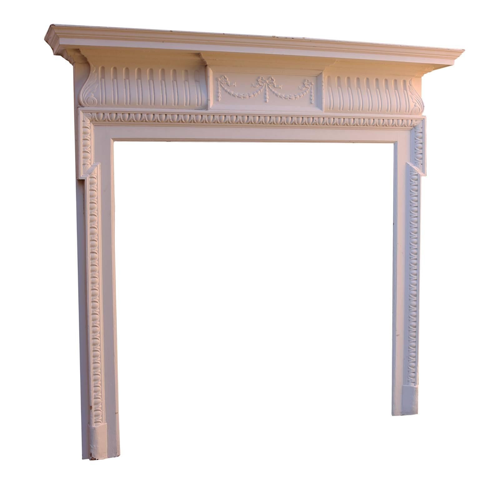 Late 19th century painted pine and composition fire surround. 
Measures: Opening height 102.5 cm. Opening width 103 cm.
