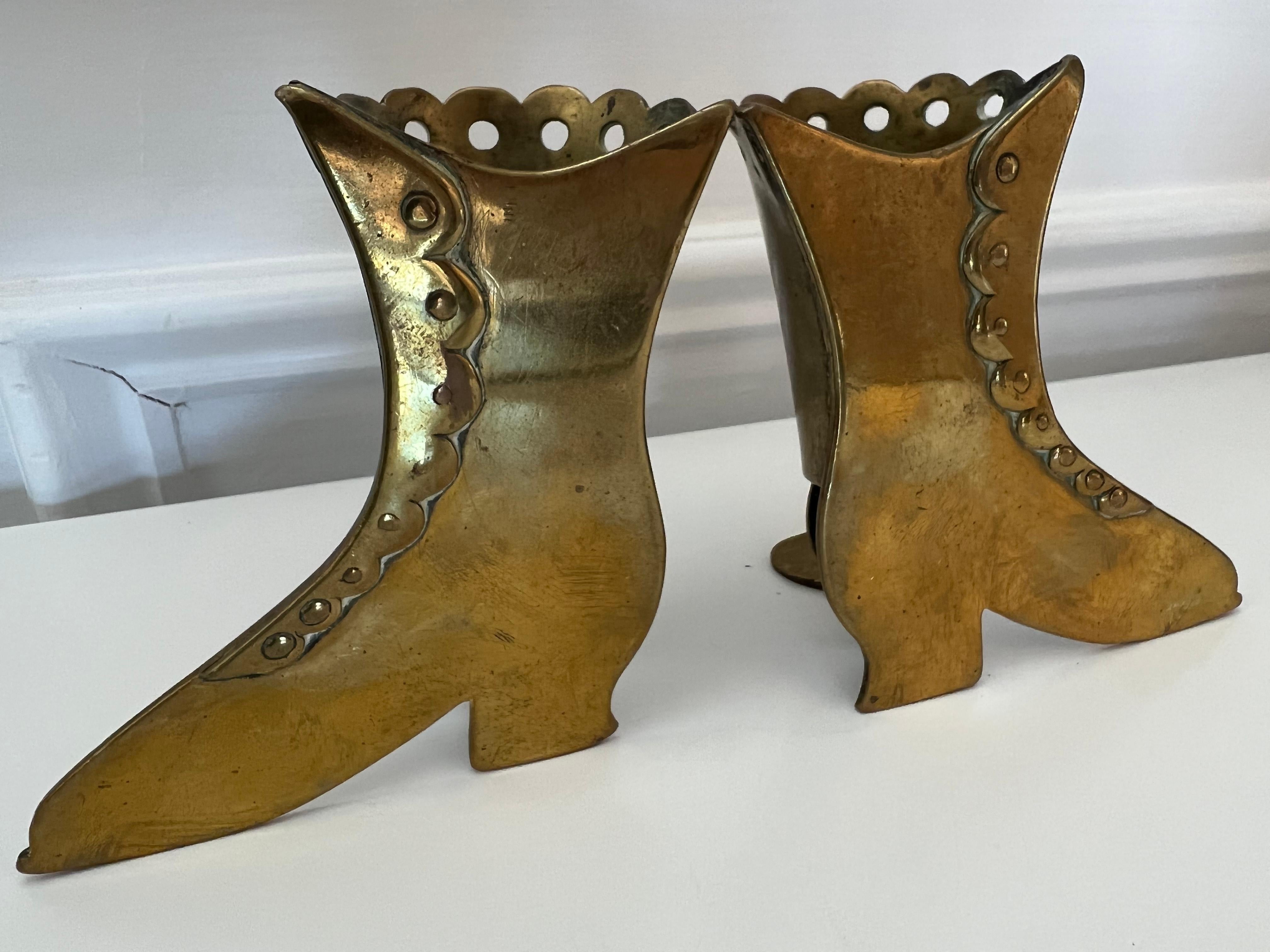 Late 19th century pair of solid brass high top shoe spills-vases with heels and buttons. A nice pair of shoe spills circa 1870 London England. From a private collector who traveled the world buying great pieces.