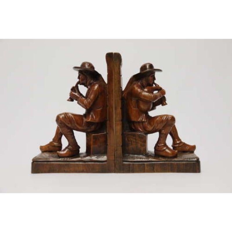 A Fine Pair of Black Forest Carved Walnut Bookends, Circa 1900

This decorative and rare pair of black forest walnut bookends are carved in solid walnut each from one piece of rich dense timber in the form of two 18th century rural musicians. They