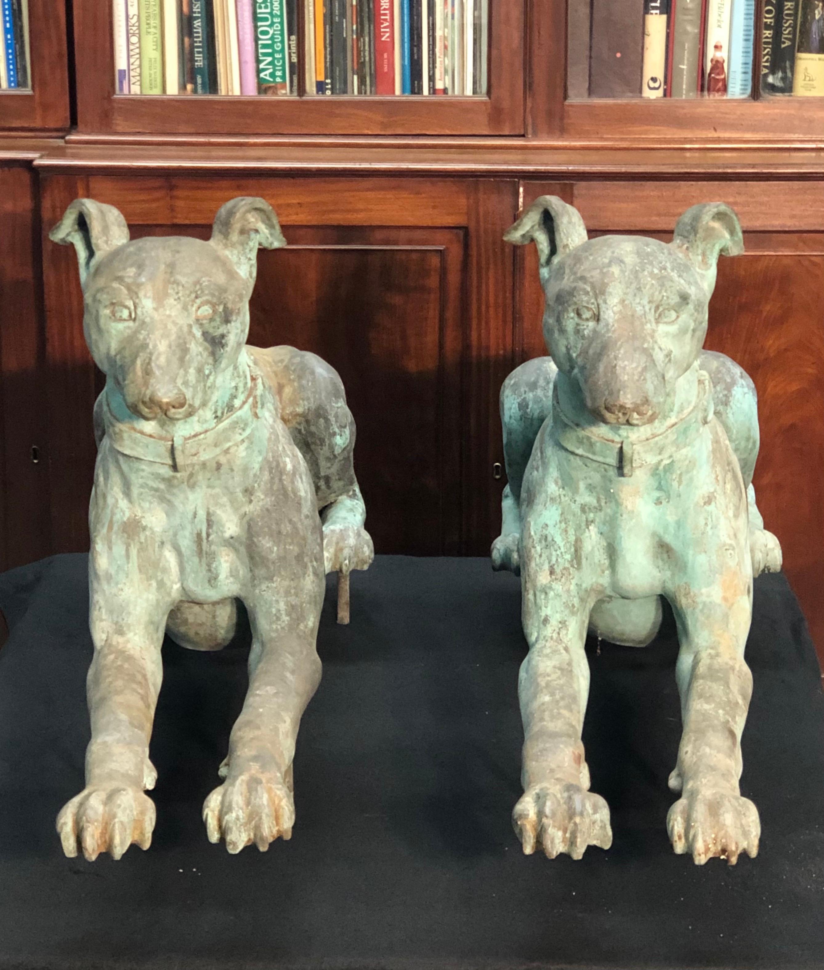 This elegant Pair of Imposing Greyhounds are life-size and finely cast bronze. The dogs are identical with refined definition and detail giving them a lifelike presence. The base of the dogs retain all but one of the original mounting pins to set