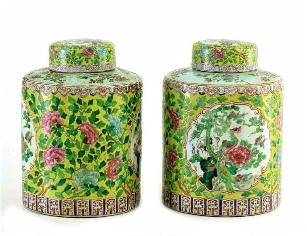 Antique pair of porcelain ginger jars or storage jars with lid crafted in China, late 19th century. These jars are colorful hand painted with a bird at both sides and rich floral motifs, the decoration on the lid is a mirror image of the jar