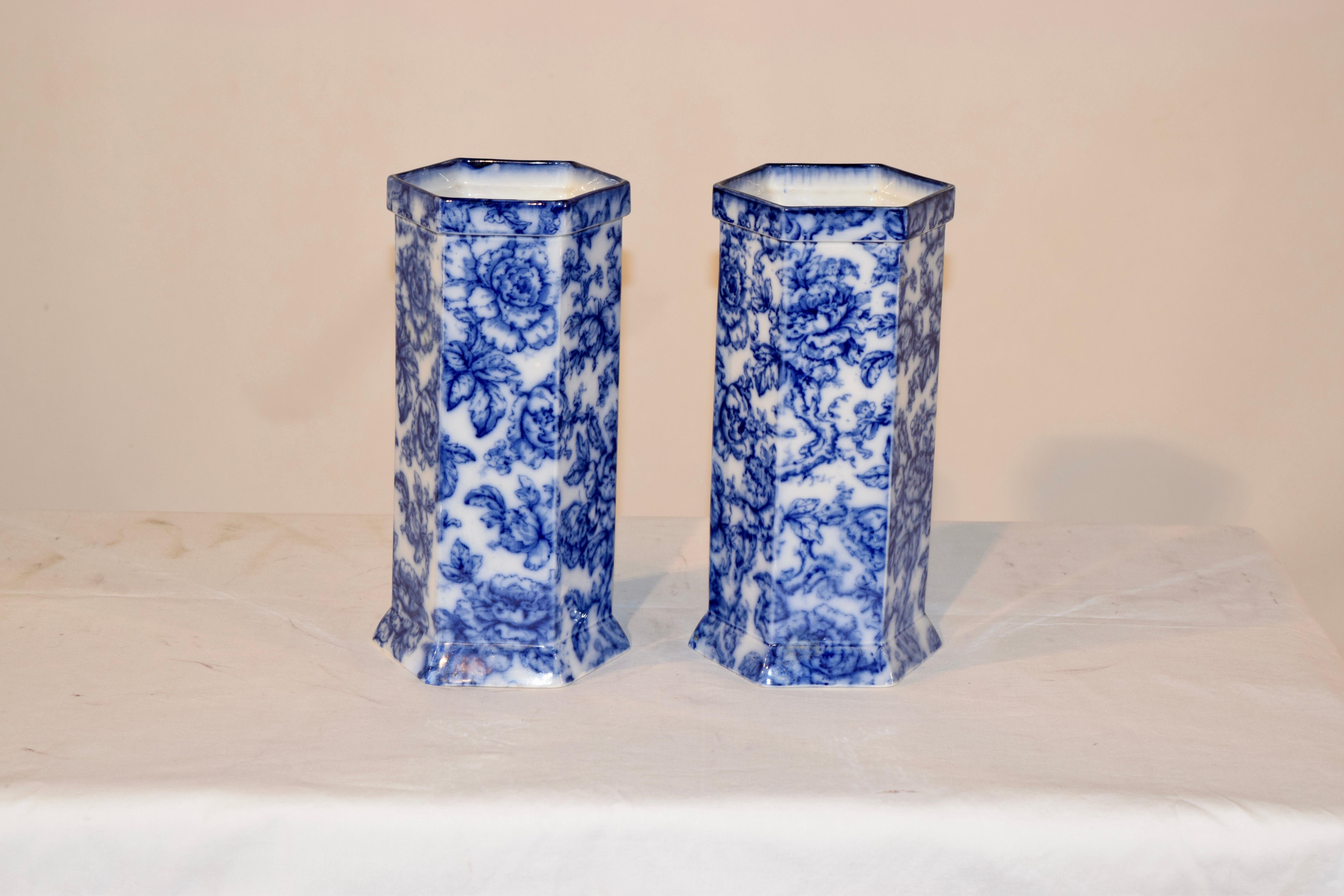 19th century pair of English porcelain vases in the Cavendish pattern by Keeling & Co. Wonderfully shaped 6 sided cylinders with collars at the top and flared rims at the bottom for added flair. The pattern is of florals and branches.