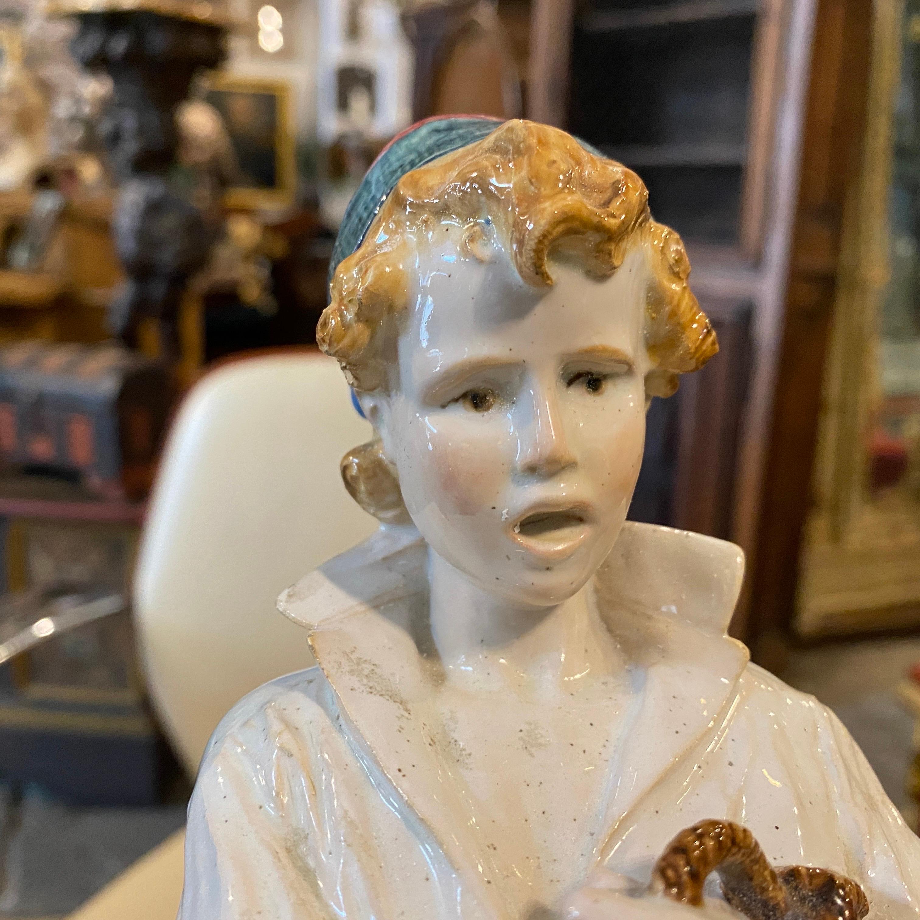 Pair of Majolica statue in the shape of a boy and a woman with basket designed by Urbano Lucchesi for Ginori Doccia factory (Florence), around 1888-1889. Majolica decorated with polychrome enamels under the showcase. They are in good condition
