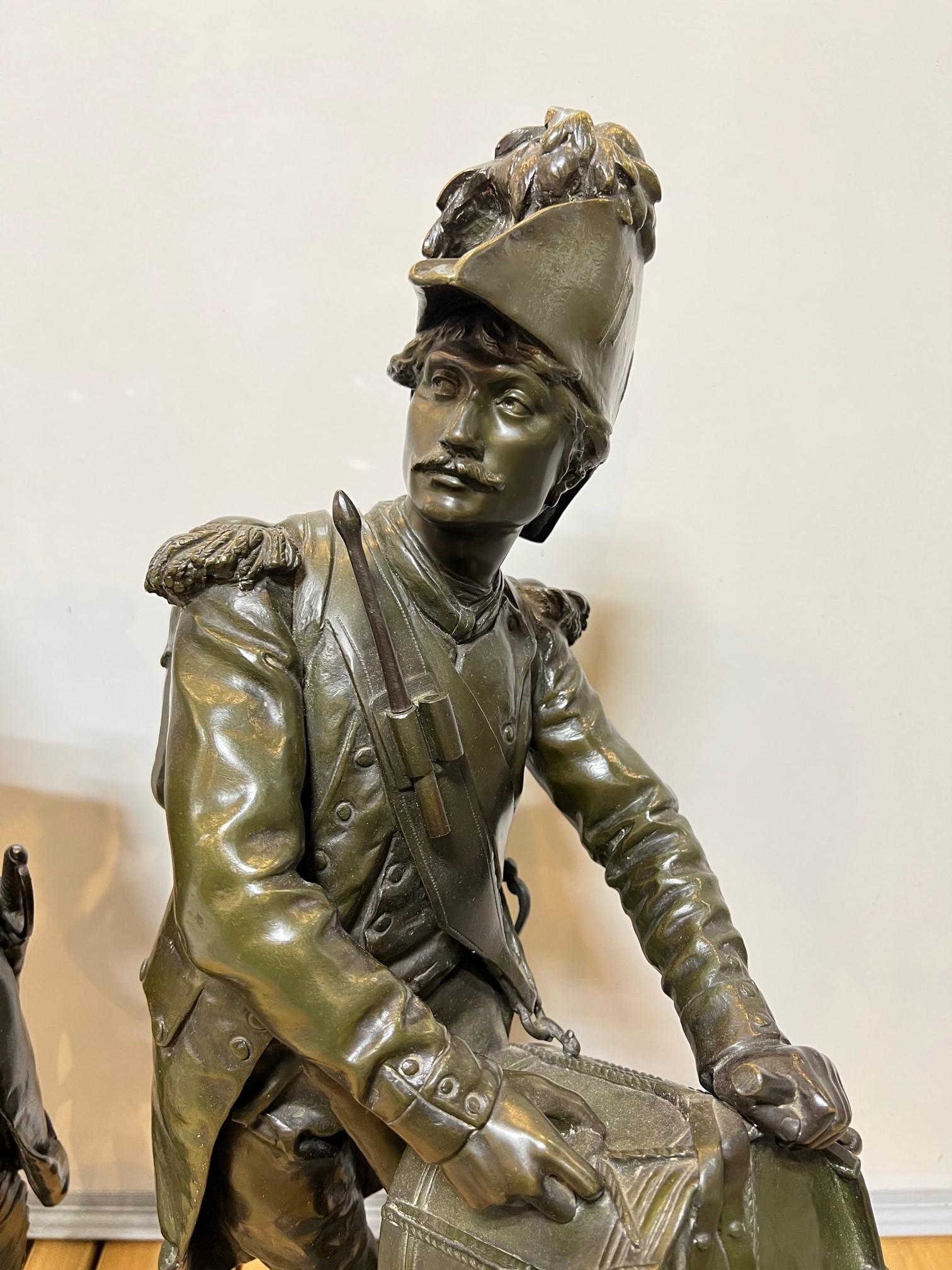 Late 19th century pair of bronze French soldiers by Etienne Henri Dumaige. Representing two separate moments in the French Revolution, the uprising against Louis XV, and the fall of the monarchy in 1792. One of the soldiers is an infantryman smoking