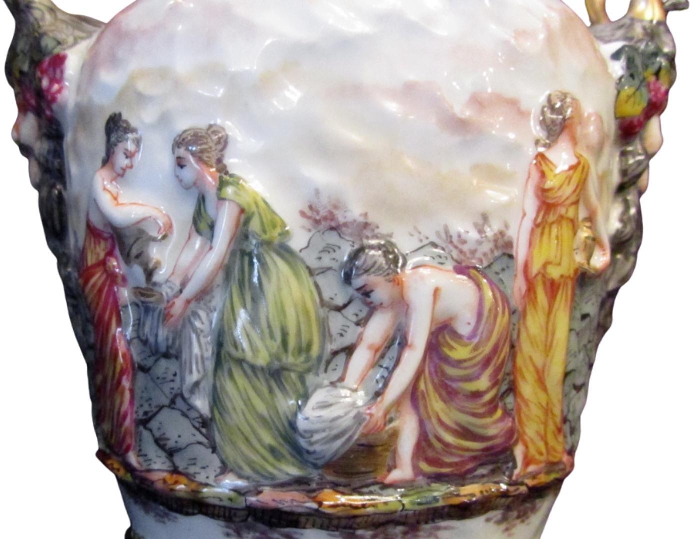 An exquisite pair of classically shaped porcelain two-part bolted urns with covers
Capodimonte.
The urns feature a continuous procession of servants in various duties.
Handles with figurehead terminations
Capodimonte marks with blue crowned