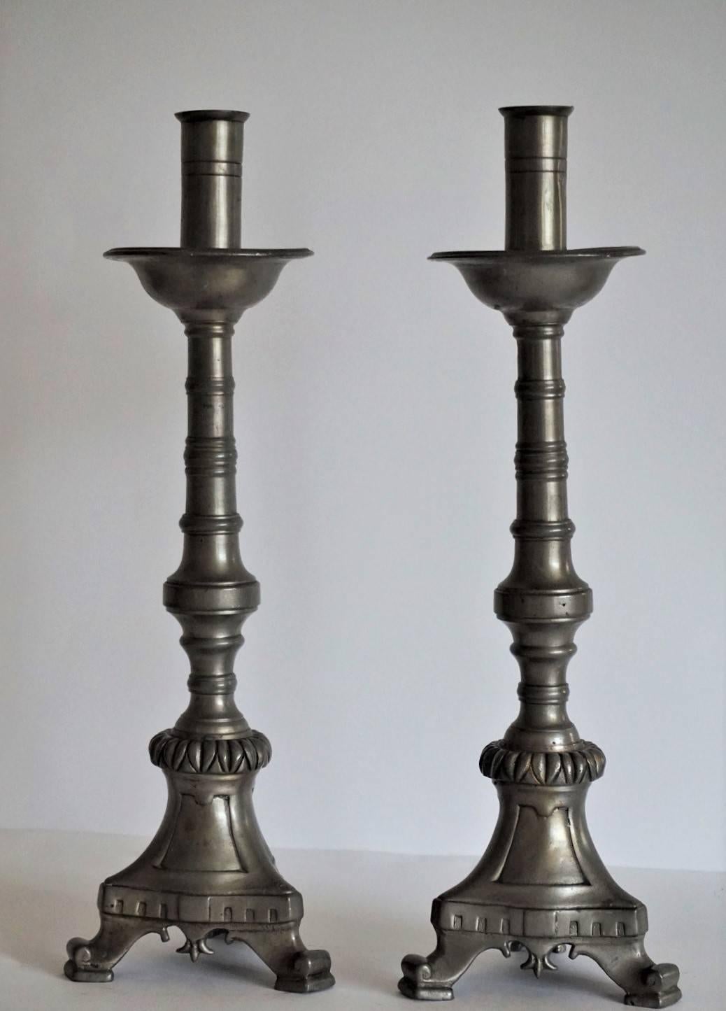 A pair of Scandinavian pewter altar candlesticks of Gothic form, probably, Swedish, late 19th century. Turned column raised on tripod base, good condition.

Measures: Height 17 in (43 cm)
Width/depth 4.75 in (12 cm).

                