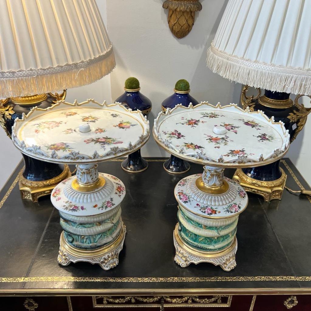 We are delighted to present you with this unique find- an exceptional pair of Parisian porcelain serving bowls/platters, boasting an intriguing design with eels gracefully coiling around the bases. These 32 cm diameter platters are adorned with