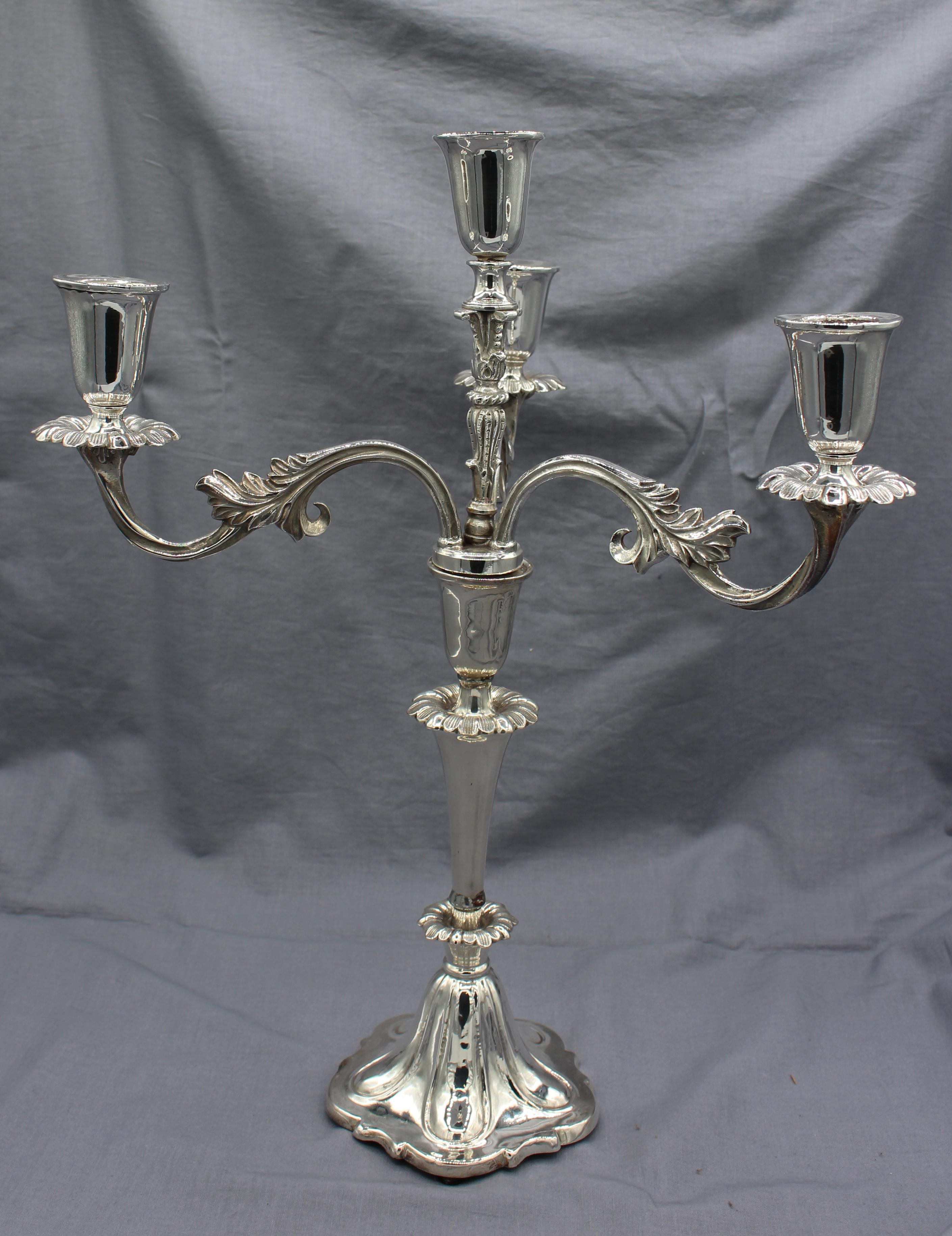 A pair of silver plated 4-light candelabras, late 19th century, Continental, German & Swiss history. Lobed petal form bases rising through leaves into rococo style arms. One shaft repaired above first ring of leaves. Well weighted.
15 1/4