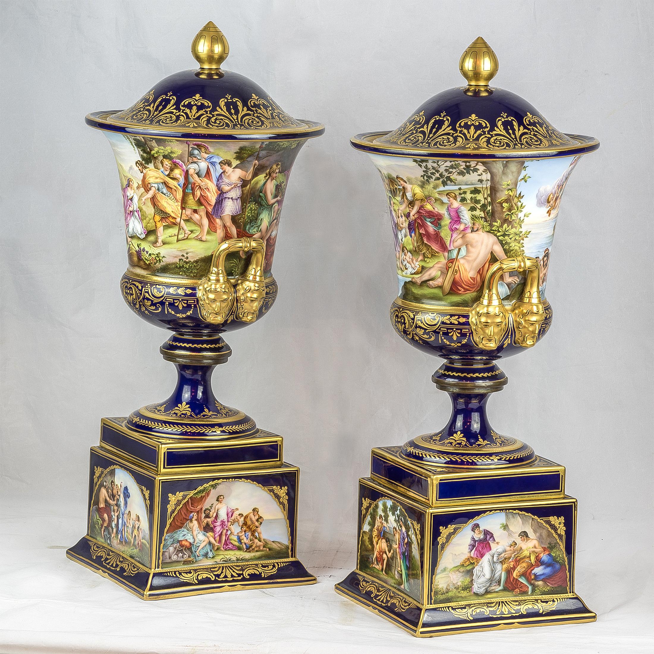 A very fine pair of Vienna cobalt blue porcelain covered urns with male mask handles. Each covered urns and covers; cobalt blue ground; loop handles terminating at classical male mask heads; allegorical figures titled under the base of one Romulus