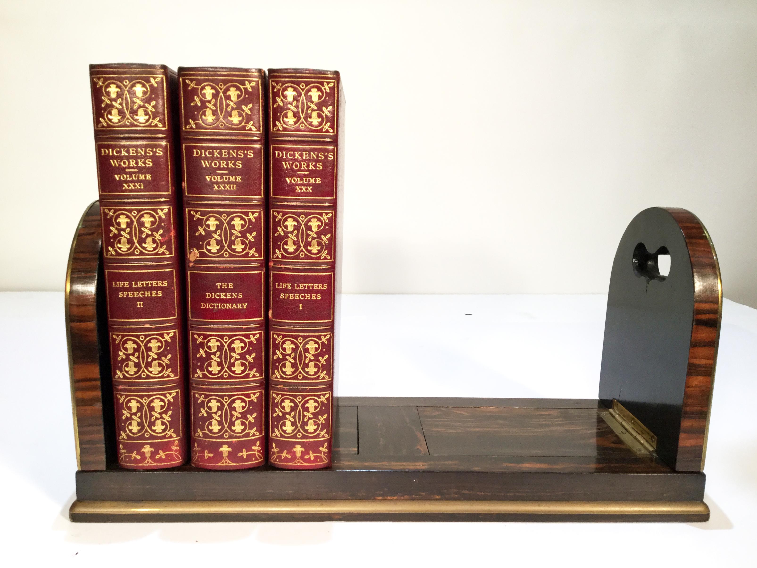 This unusual Military Campaign Coromandel bookend is adjustable for sliding and folds together which makes for easy travel. It has brass trim along the edges with pierced cut outs for fingers on the Gothic Arches that are either side. It also