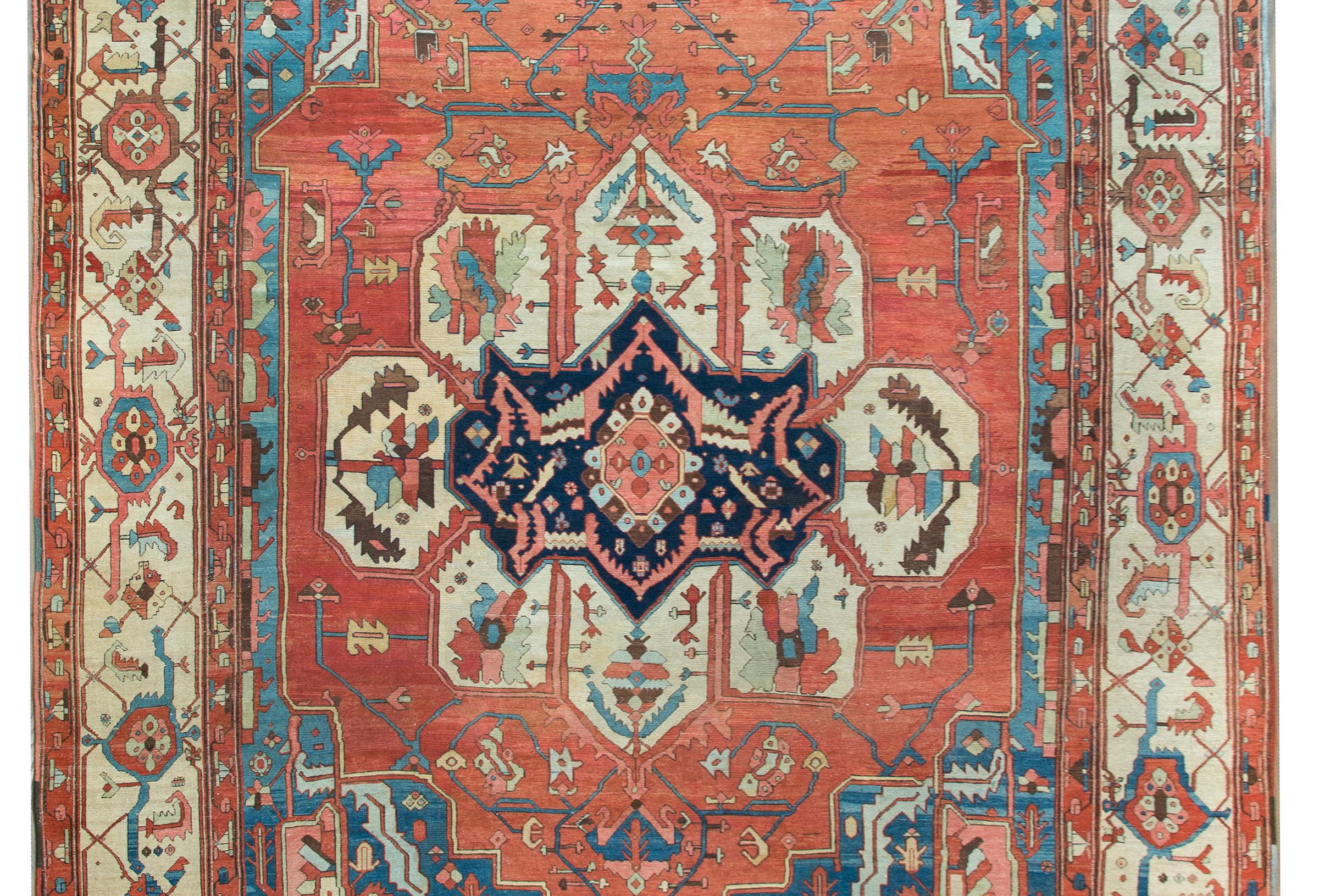 A stunning and one-of-a-kind late 19th century Persian Bakshaish rug with most wonderful asymmetrical central floral medallion woven with myriad stylized large-scale flowers, leaves, and scrolling vines woven in light and dark indigo, pink, crimson,
