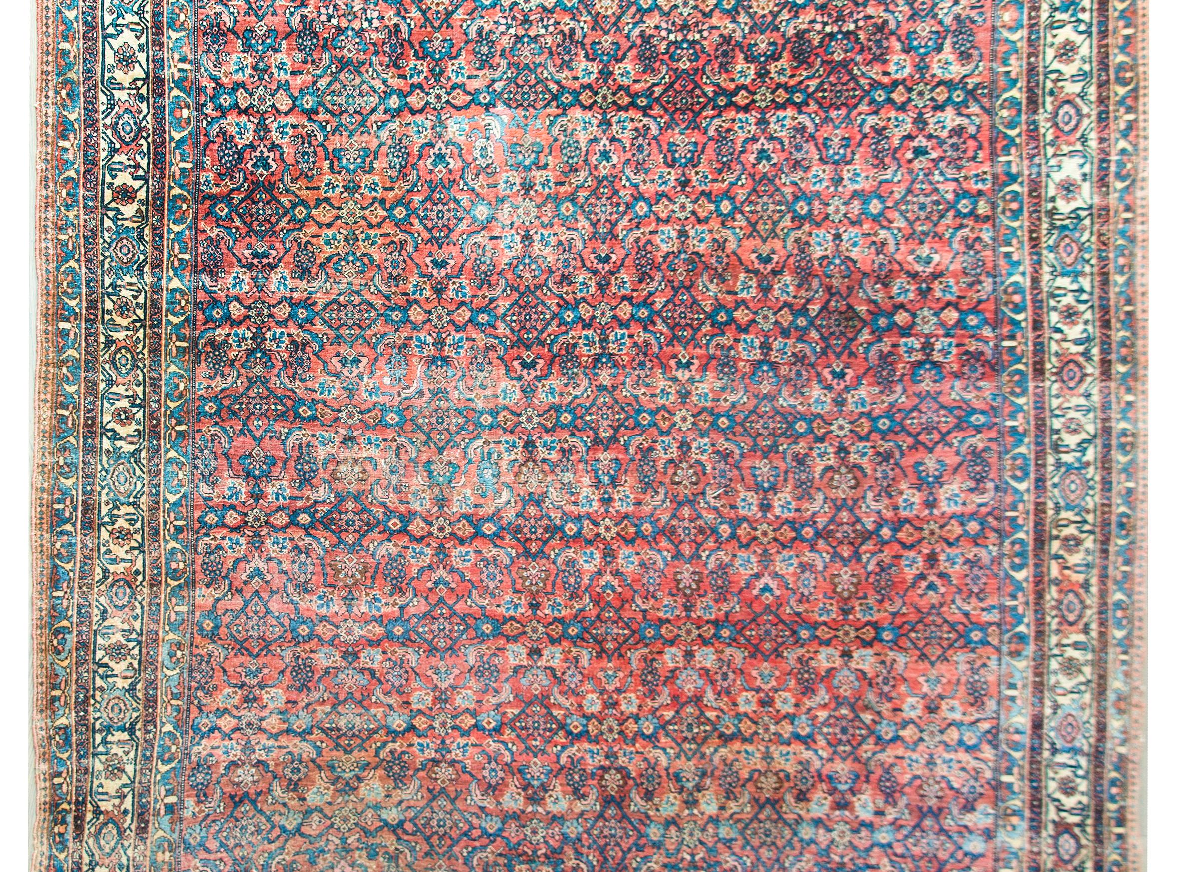 An incredible late 19th century Persian Bidder rug with the most beautiful all-over trellis and floral pattern surrounded by a a complex border containing multiple thin matching floral patterned stripes, all woven in light and dark indigo, cream,