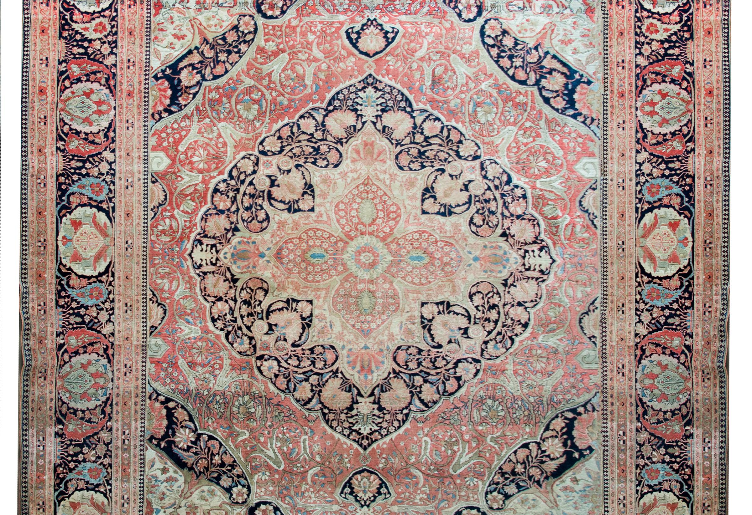 A stunning and rare late 19th century Persian Mohtasham Kashan rug with the most mesmerizing intently woven floral patterned medallion living amidst an equally incredible field of more flowers and scrolling vines, surrounded by an amazing border
