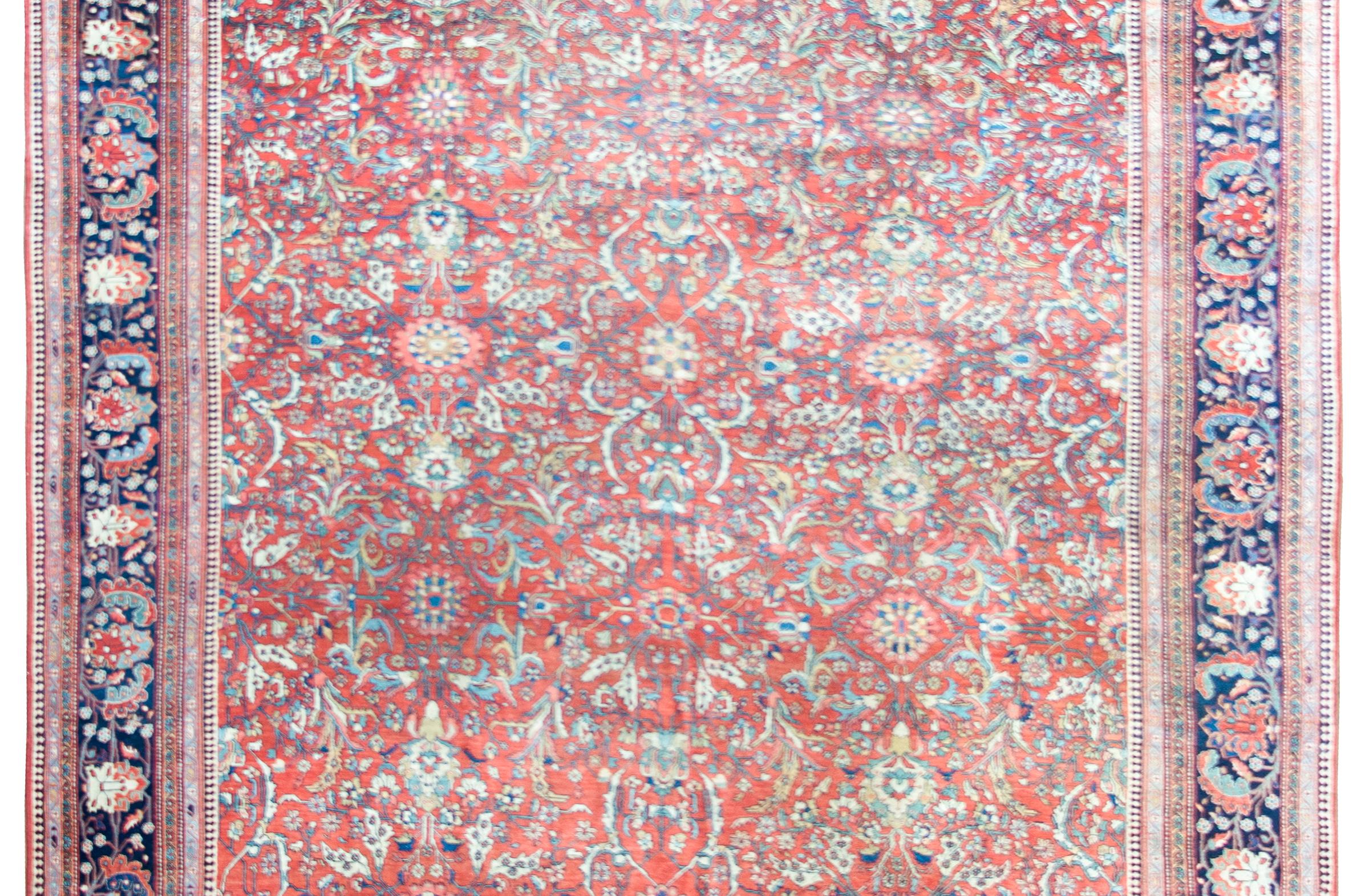 Superbe tapis persan Sarouk Farahan de la fin du XIXe siècle, avec un champ à motif de treillis floral et de vigne en spirale tissé avec des fleurs et des feuilles de grande taille, entouré d'une incroyable bordure avec d'autres fleurs de grande