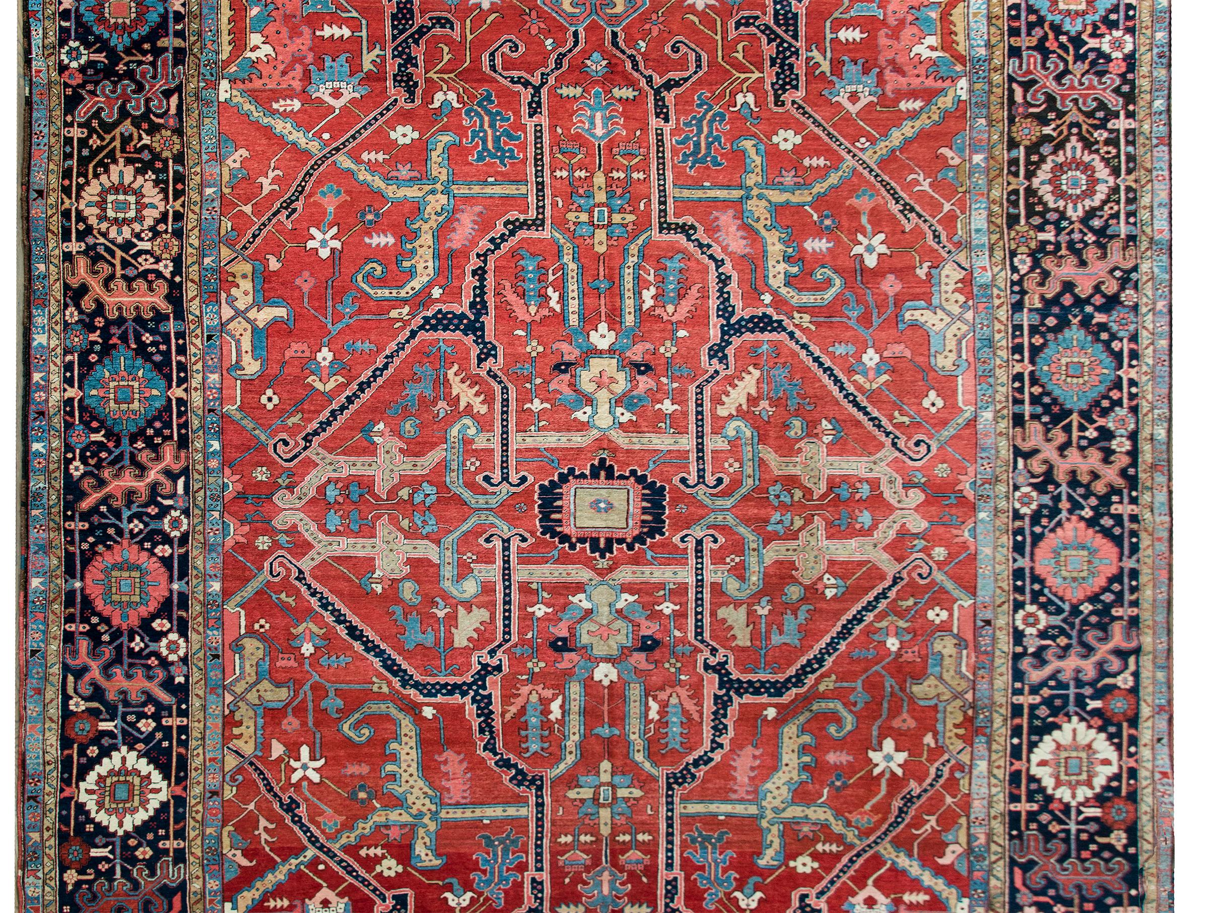 An unbelievably beautiful and rare late 19th century Persian Serapi rug with one of the most beautiful patterns we've ever seen in this style rug. A small central floral medallion is surrounded by stylized swirling and scrolling vines and woven in