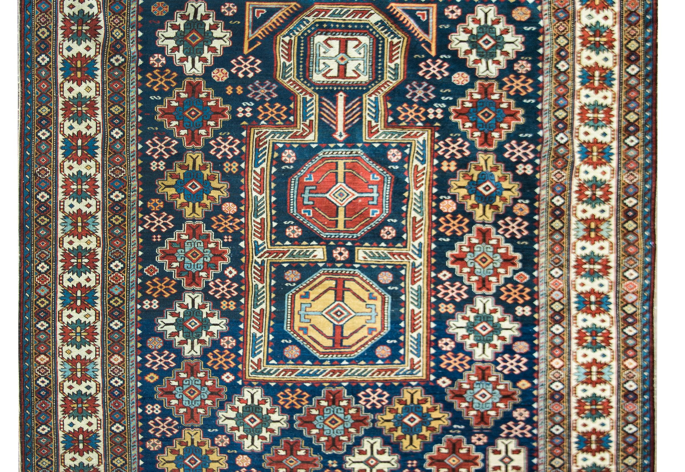 A striking and memorable late 19th century Persian Shirvan rug with the most wonderful field with repeated stylized flowers surrounding a central medallion with more stylized flowers. The border is incredible with multiple thin and wide stripes with