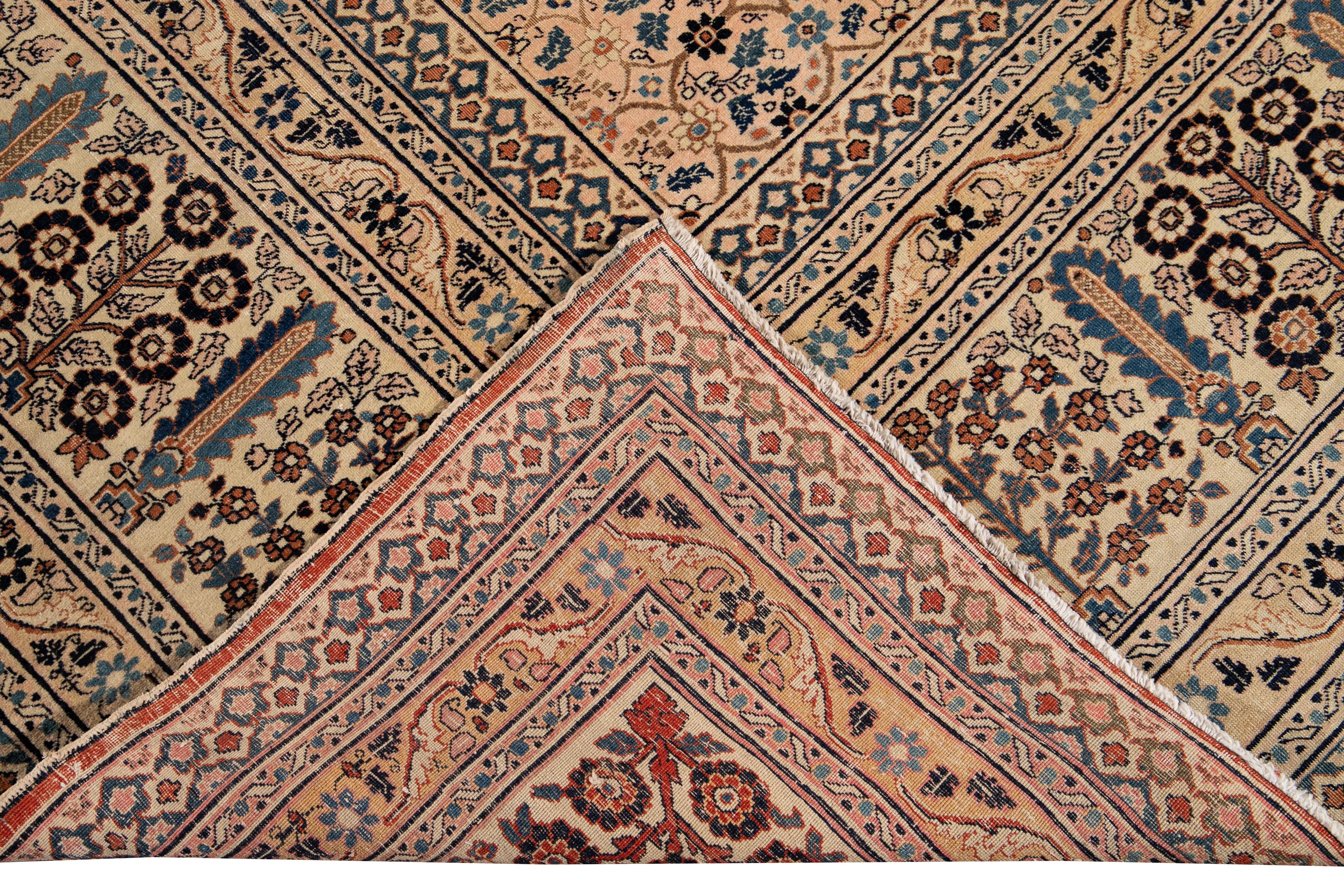 Beautiful antique Persian Tabriz hand knotted wool rug with a peach field. This Tabriz has accents of blue, rose, and brown in a gorgeous all-over geometric floral shabby chic design.

This rug measures: 9'9