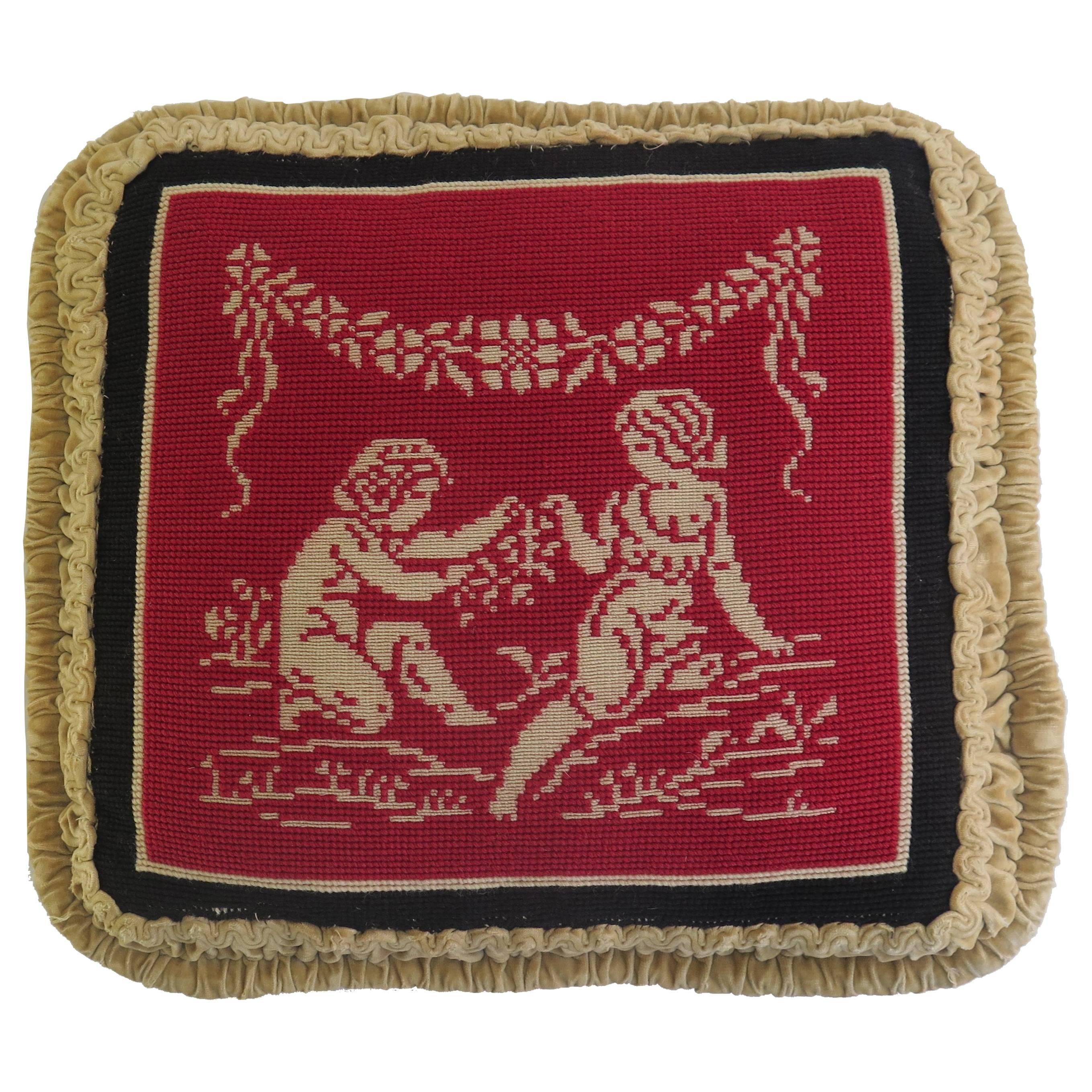 This is a very attractive and unusual needlepoint tapestry pillow or cushion with a classical design, which we date to the late 19th century. 

The classical themed design depicts two figures ( male and female - cupid’s lovers?) in a light cream,