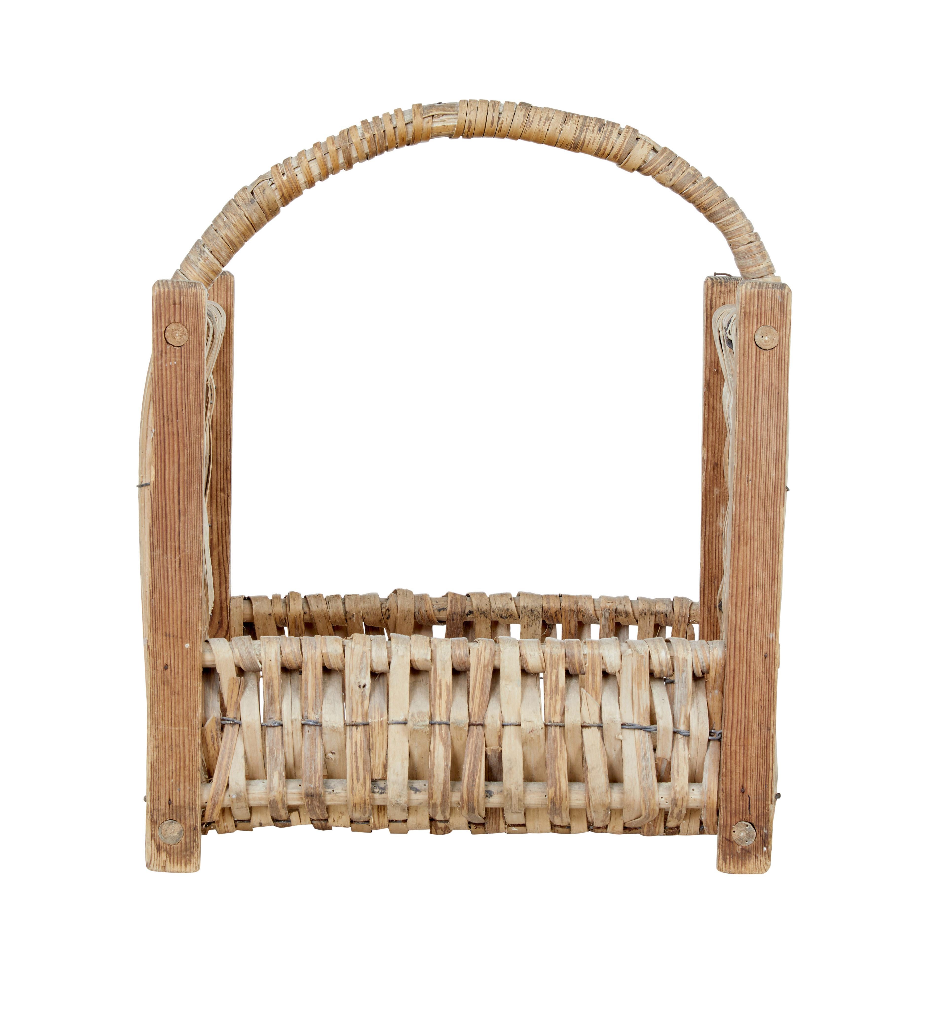 Late 19th century pine and wicker log basket circa 1890.

Fine example of Scandinavian pine craft work. Pine frame secured by dowel with original wicker weave. Ideal for use as a log basket or for decoration.

Expected minor losses to cane, but
