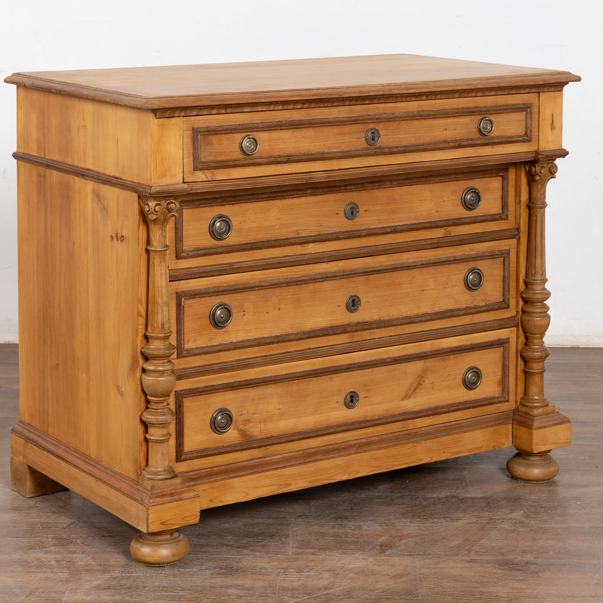 This large pine chest of four drawers has turned columns accenting the central three drawers which are slightly inset creating beautiful visual appeal.
Restored, this dresser is strong, stable and ready for use. Note the natural wax finish that