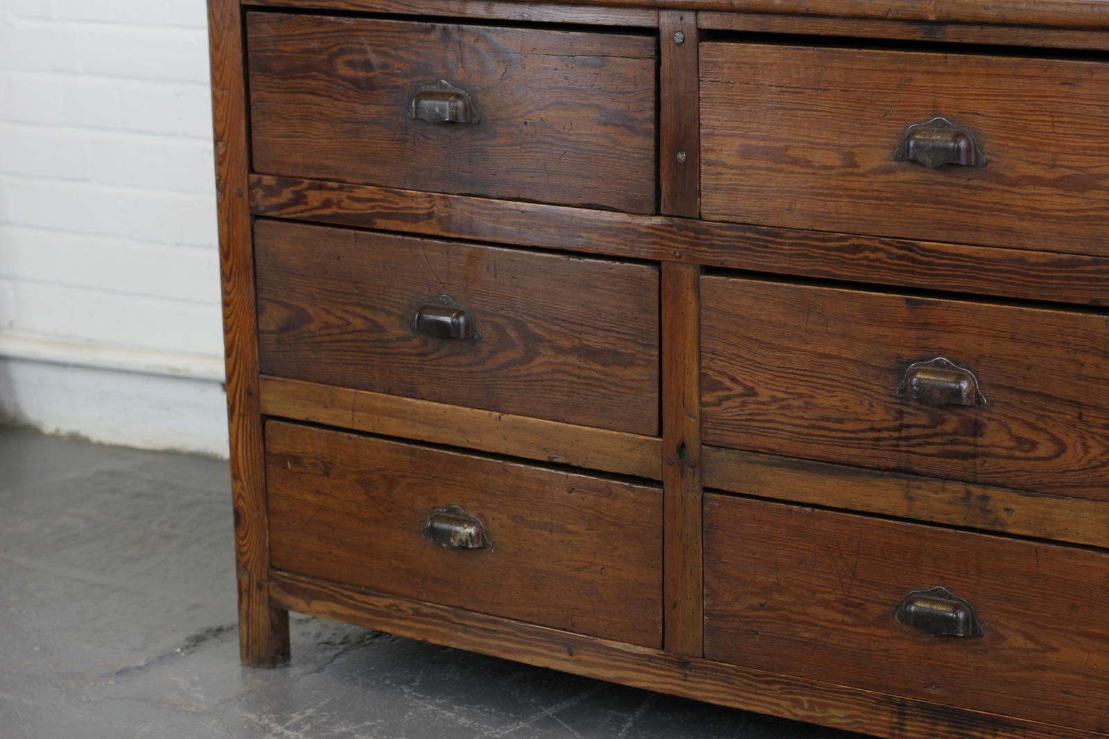 Late 19th century pine factory drawers 

- Solid pine frame and drawers
- Heavy cast steel handles
- Nine large drawers
- French, circa 1890
- Measures: 181 cm long x 61 cm deep x 82 cm tall.

Condition report

The cabinet has been waxed