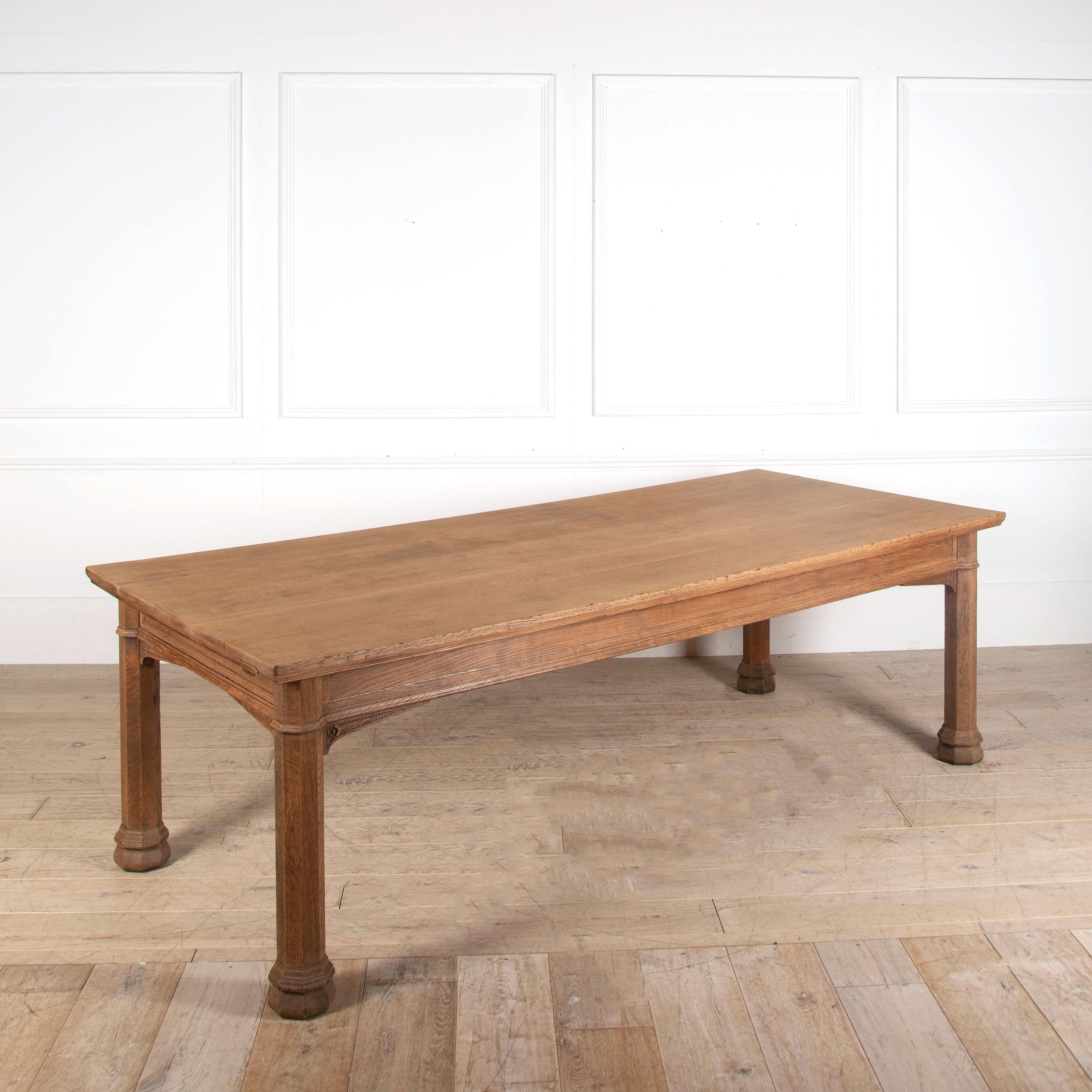 A late 19th century Pugin style Gothic light oak refectory table featuring carved lancet details and octagonal profile legs. A superbly useful size table, in dry a finish with a frieze drawer. English Country House appeal.