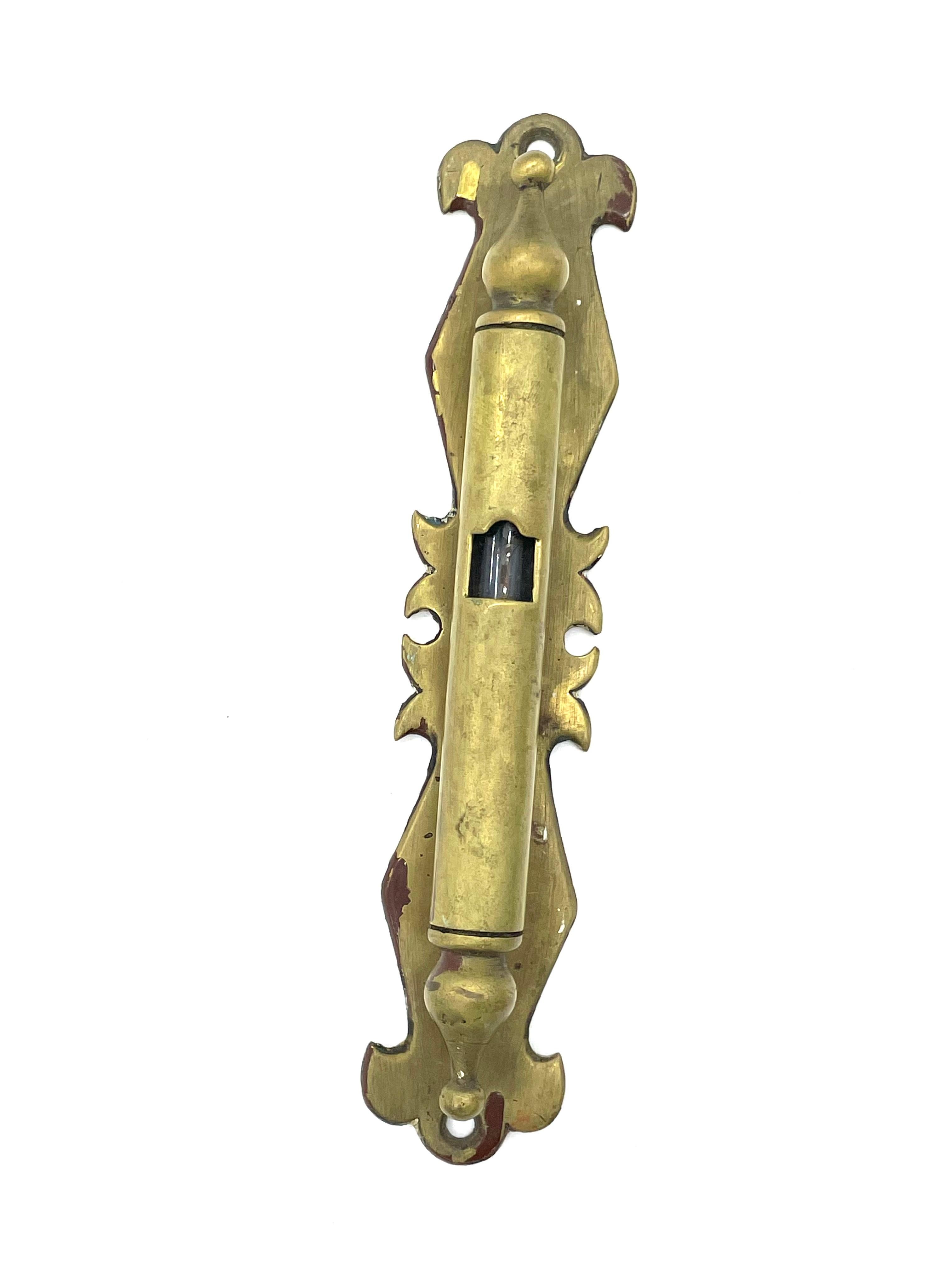 A magnificent and rare brass mezuzah case handcrafted in India circa 1880. This massive, solid mezuzah case was made by a Jewish artist in Cochin, the home of the oldest Jewish community in India. Shaped in a cylinder form, a bell-like ornament