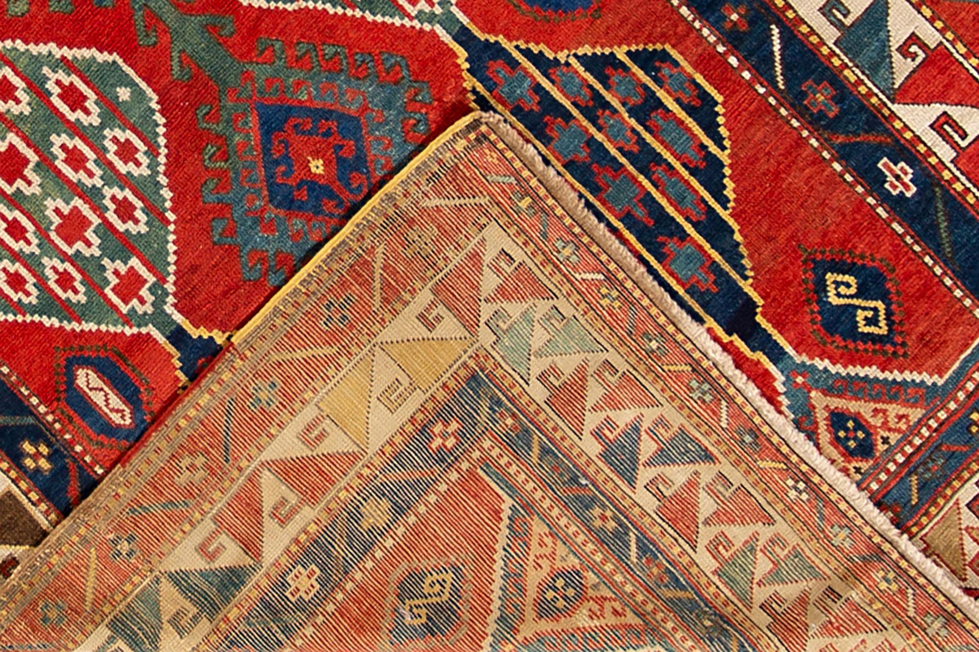 Late 19th century (1890s) Kazakh rug with a rust border and red field with a traditional design. Measures 4.07x8.