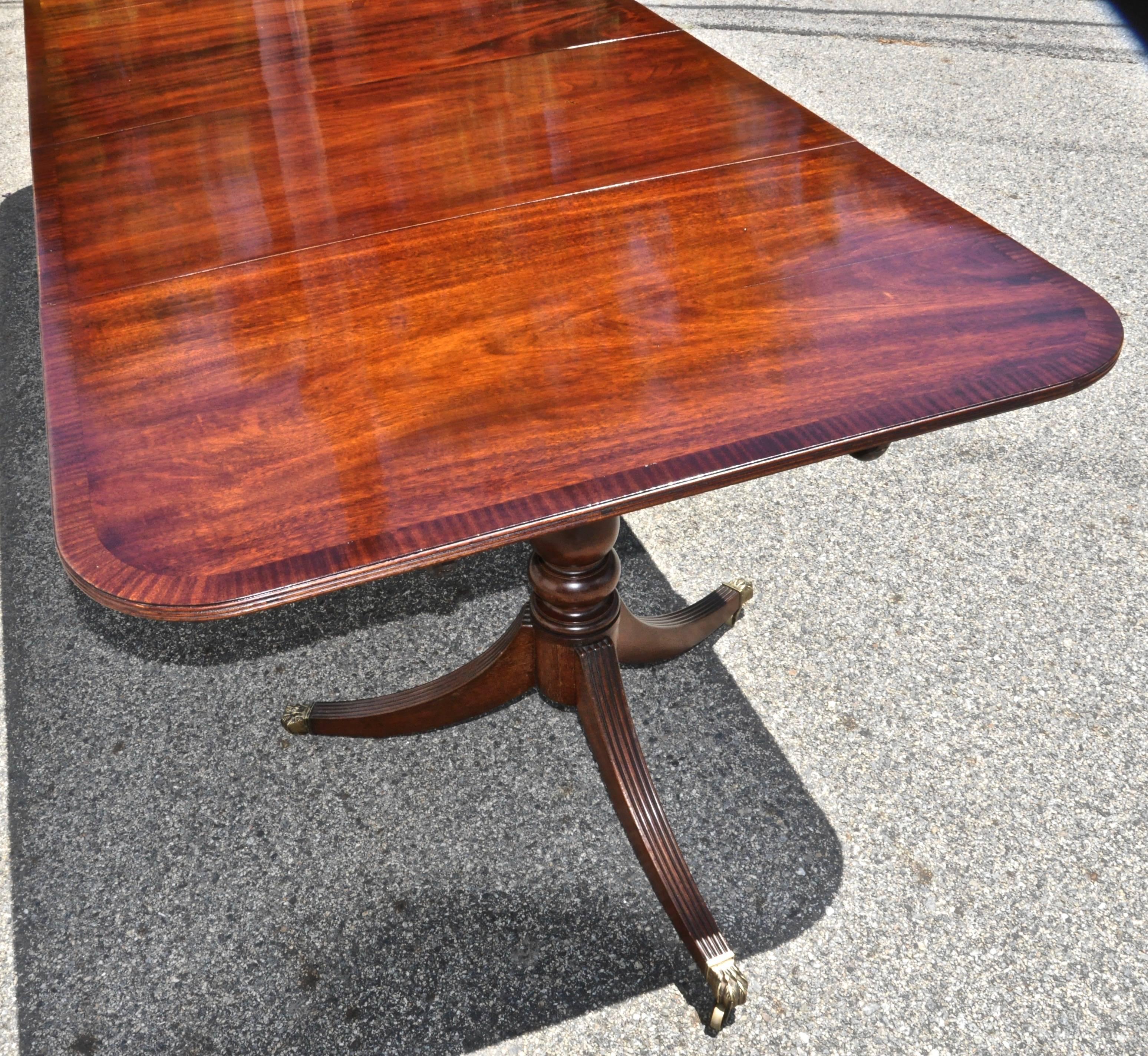Late 19th century Regency style of Duncan Phyfe style three pedestal dining table.

--With two additional original leaves
--Solid mahogany
--Mahogany banding
--French polish.