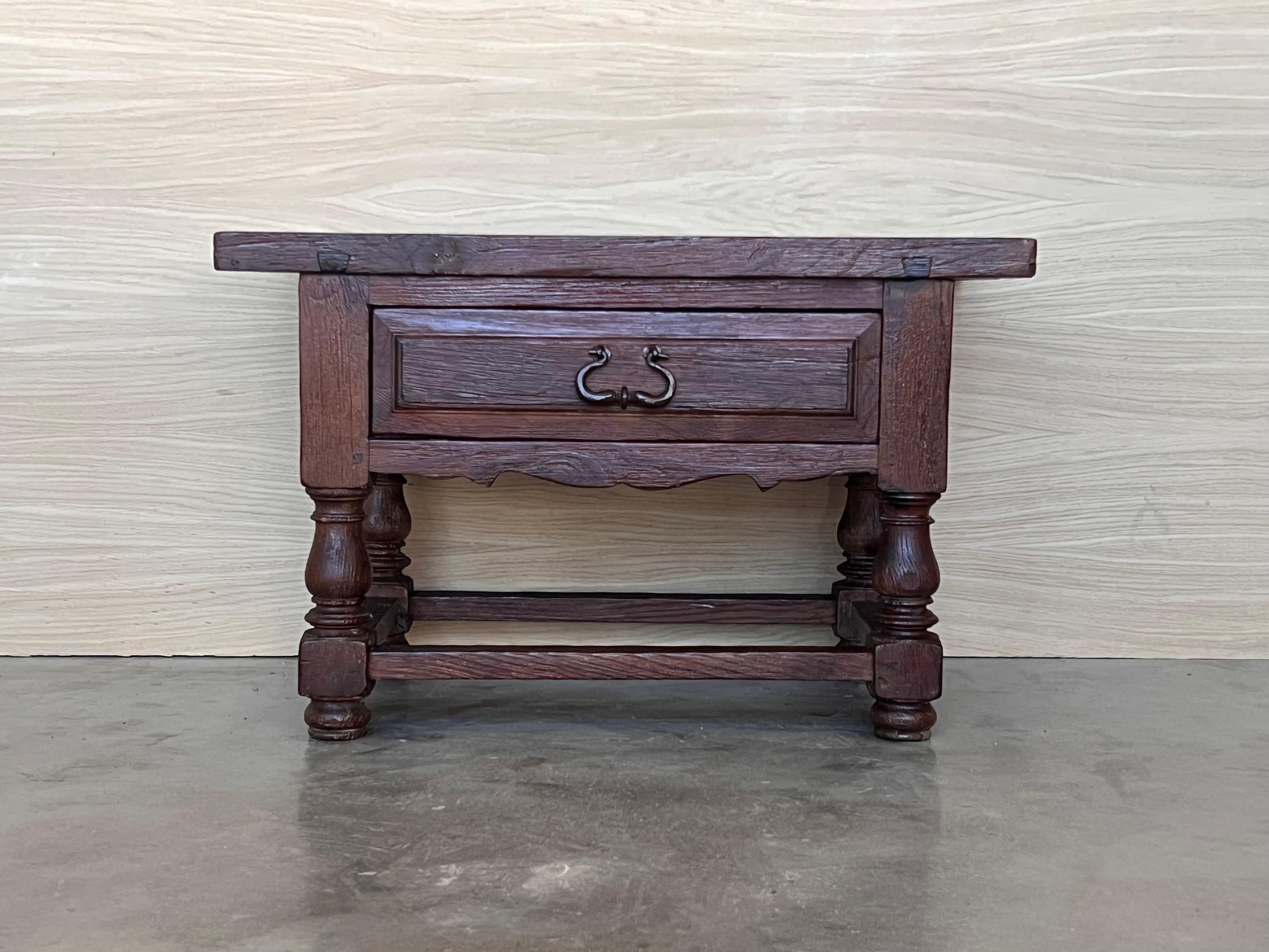 This rustic artisan made side table hails from the Pyrenees on the French-Spanish border. It is constructed from local woods and still boasts original hand forged pull. Called a 