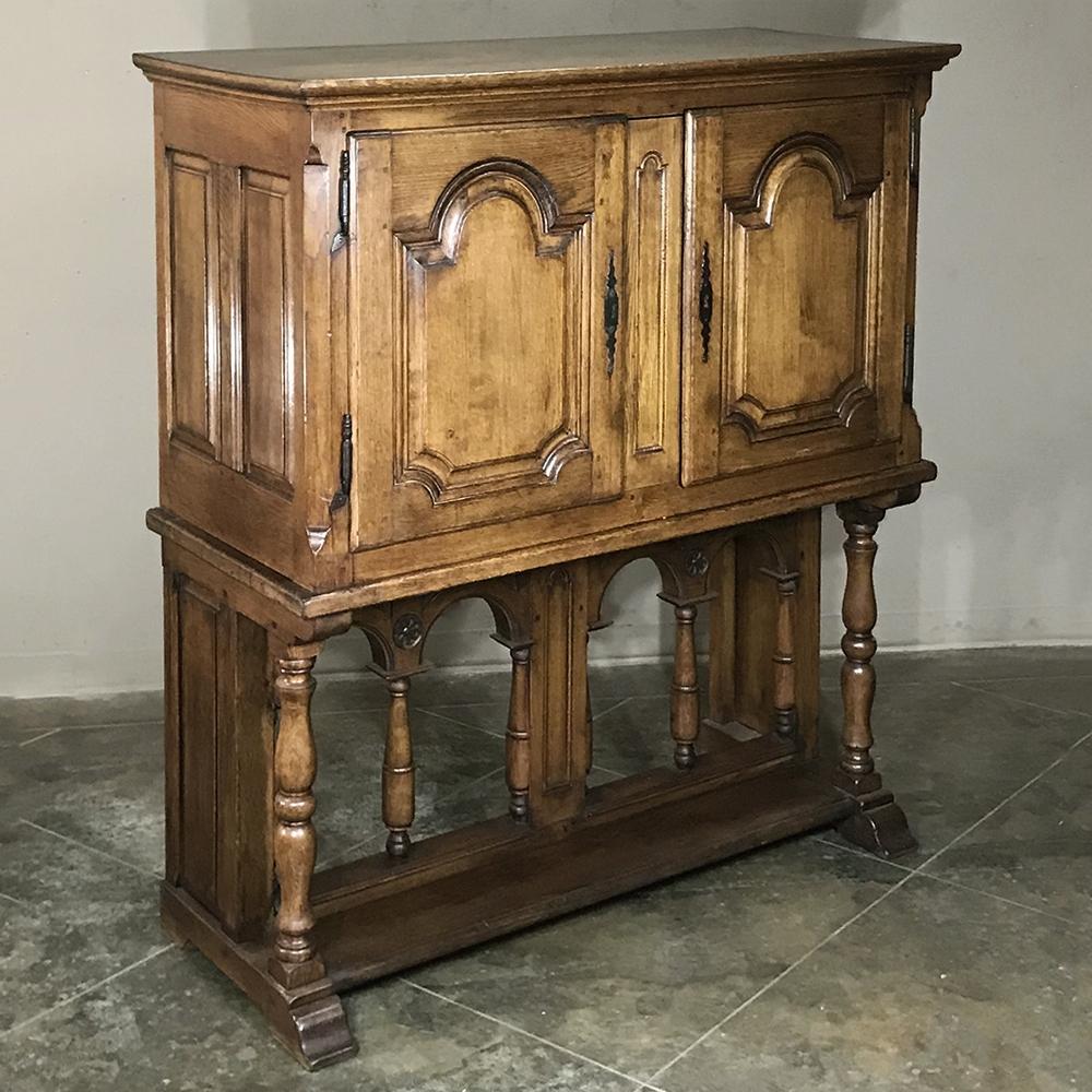 Late 19th century rustic Country French raised cabinet represents a centuries-old design that harks back to an era when specialized storage cabinets were in high demand by the affluent. This example, rendered from solid old-growth oak, features