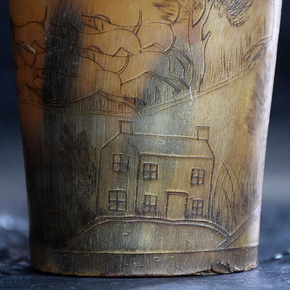 Late – 19th century scrimshaw beaker
A lovely example of a late- 19th century scrimshaw beaker. Detailed fox hunting country scene which includes men on horseback, a pack of dogs, fox, cottages, trees, shrubs, and landscape with country fences.