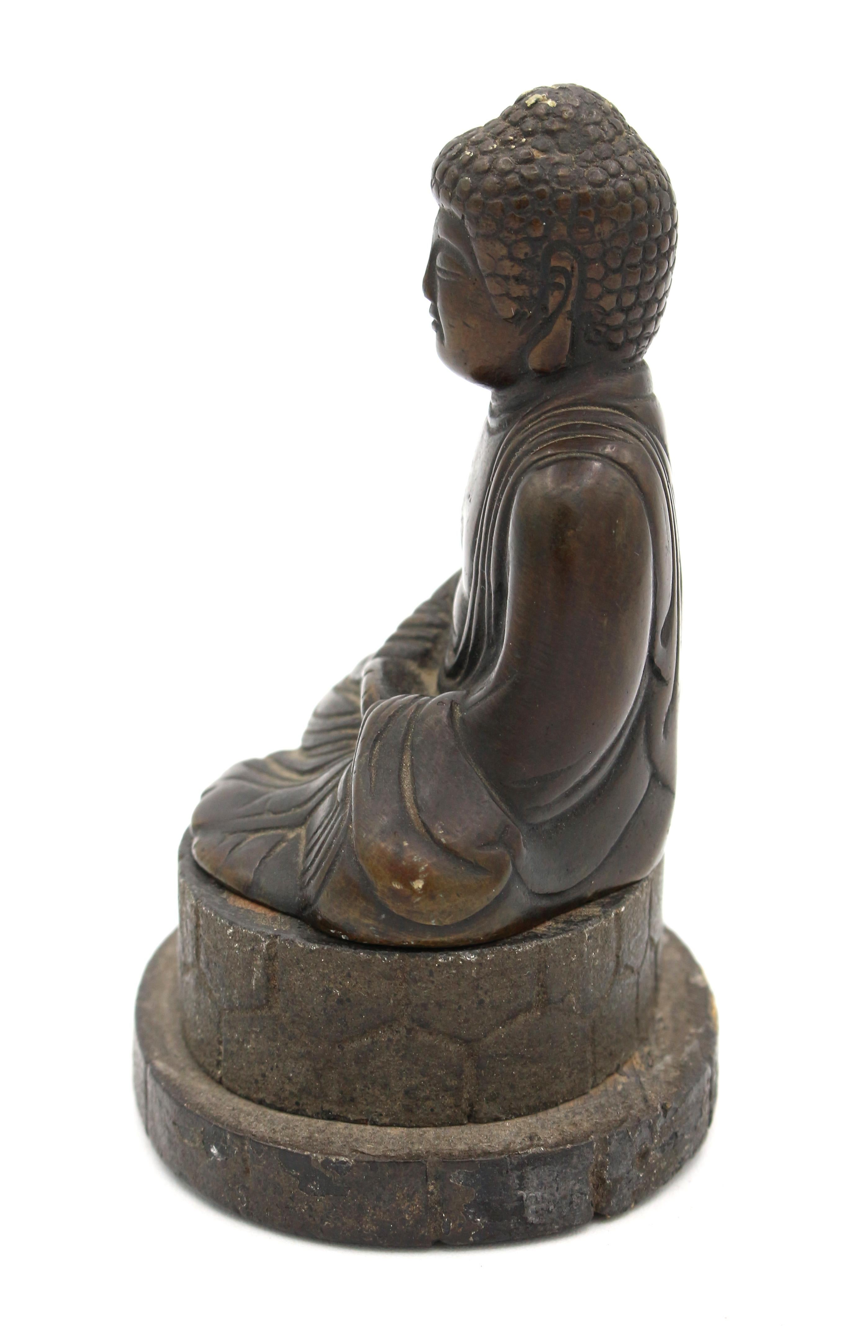 Late 19th century seated bronze meditation Buddha, Qing Dynasty. Lovely patination and nicely detailed. With a charming wooden faux stone stand (not attached).
Figure: 2.75