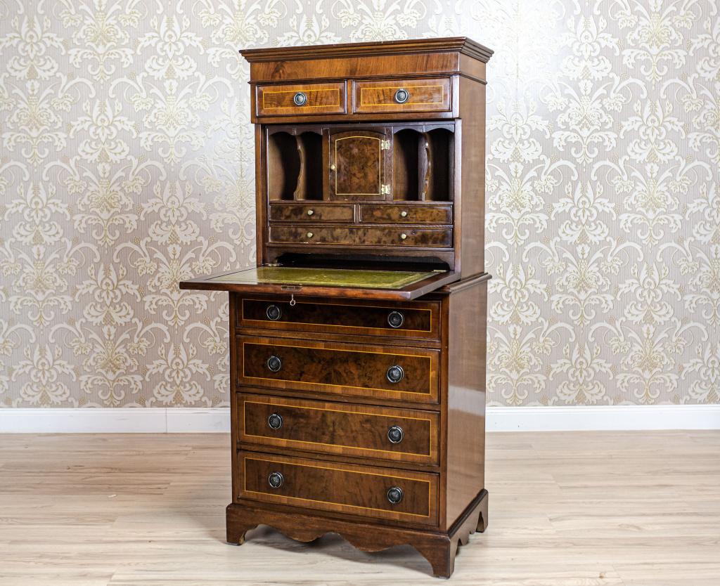 We present you a subtle 19th century secretary desk with four drawers at the bottom, two smaller ones in the upper section, and compartments hidden behind the openable door panel.

This piece of furniture has not undergone renovation.