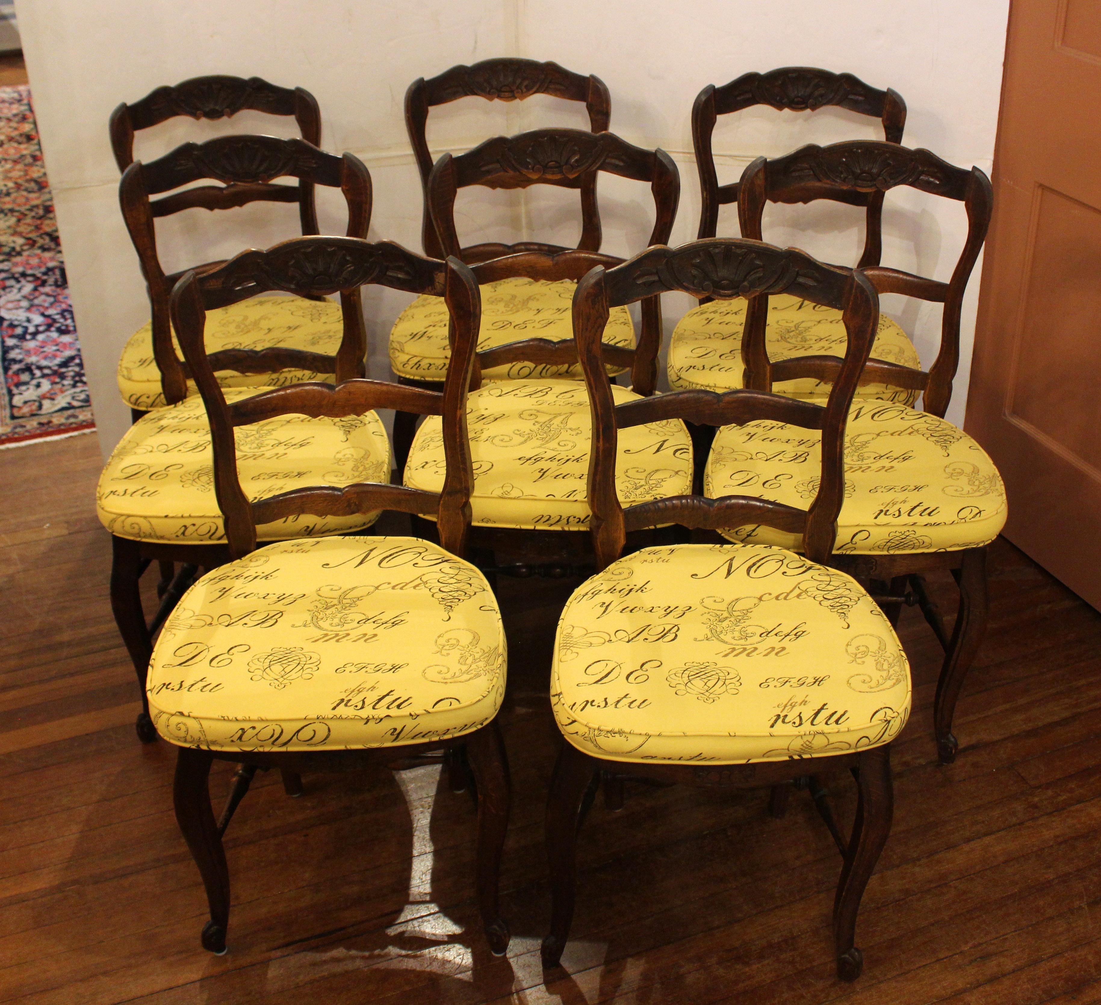 Late 19th century set of 8 country French dining chairs. Traditional ladder back form with cabriole legs, turned stretchers & shell carved crests rails & front aprons. Typical mix of woods including oak, ash & beech. Rush seats. Well maintained -