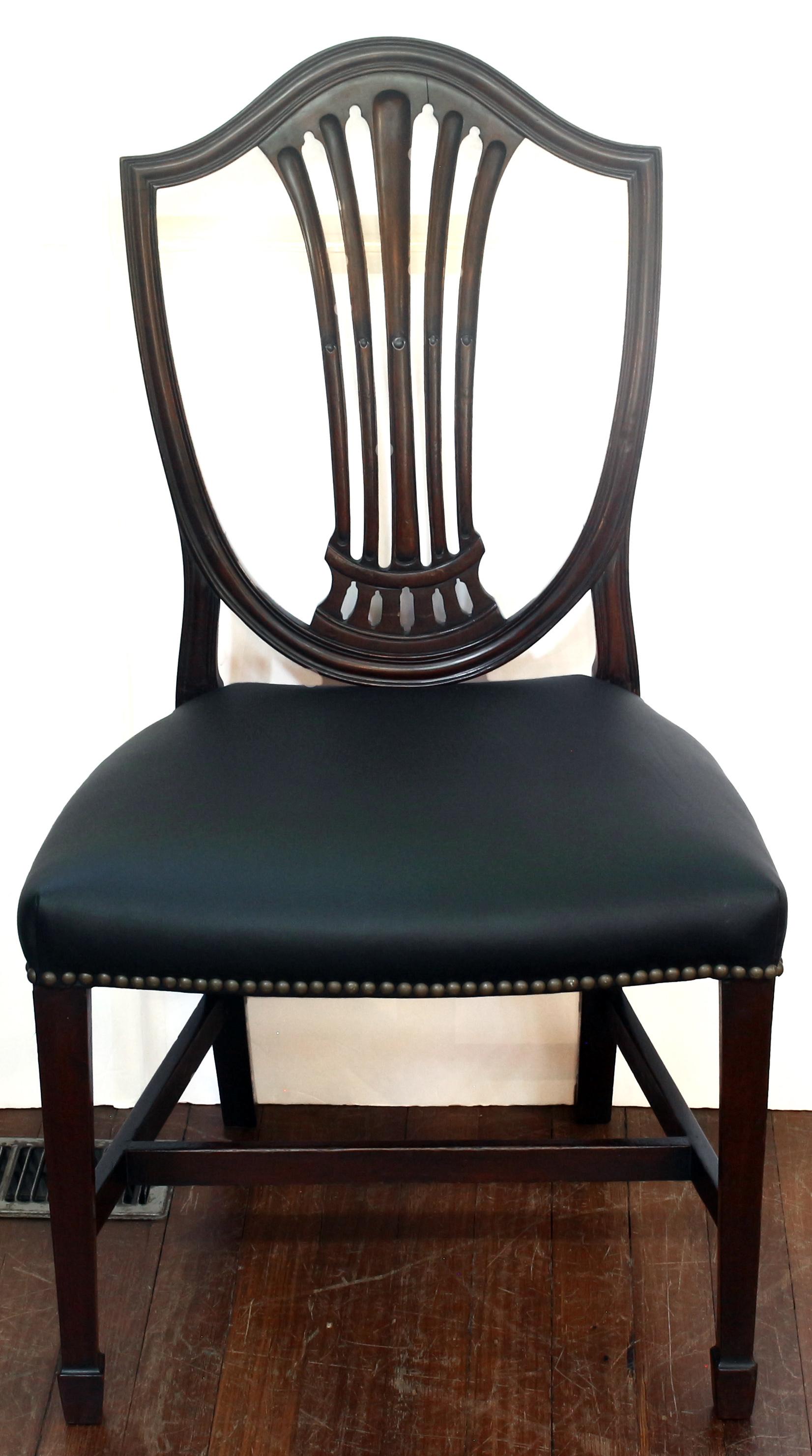 Late 19th century set of 8 Georgian style dining chairs, English. Hepplewhite style. Well molded shield backs & arms. Cut work, stop-fluted backsplats. Straight tapered legs ending in spade feet, stretchers. 1 side chair with old backsplat break