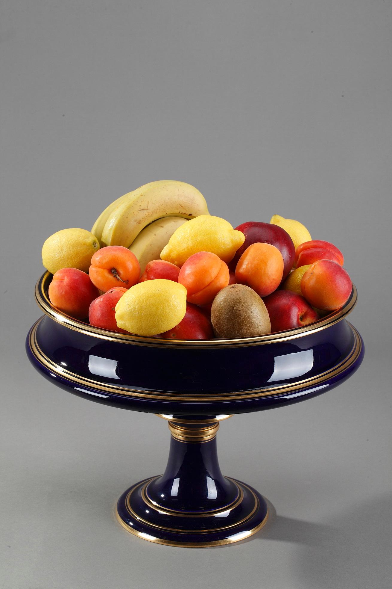 Large Sevres Porcelain display bowl resting upon a high foot. The border and foot are highlighted with gilded stripes. Manufactured by Sevres in 1878 and gilded at Sevres in 1883. Marked under the base S.78 and Doré à Sèvres 83,

circa