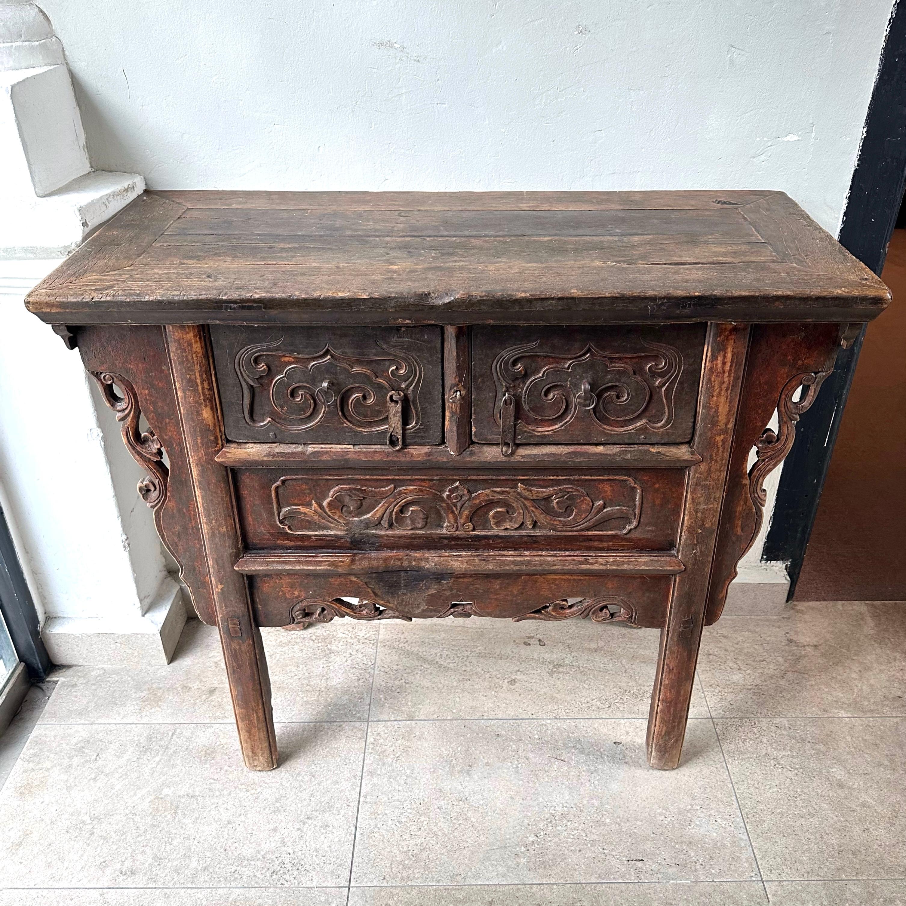 A late 19th century antique coffer table from Shanxi province, China, with excellent patina and beautiful original colour which we had left untouched. The two drawers have relief carvings of cloud motifs, and they pull out completely to reveal a