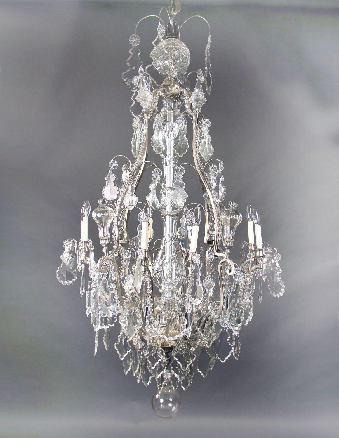 A late 19th century silvered bronze and crystal eight light chandelier

multifaceted and shaped crystal, beaded arms, cut crystal central column, 8 tiered spears with eight perimeter lights.