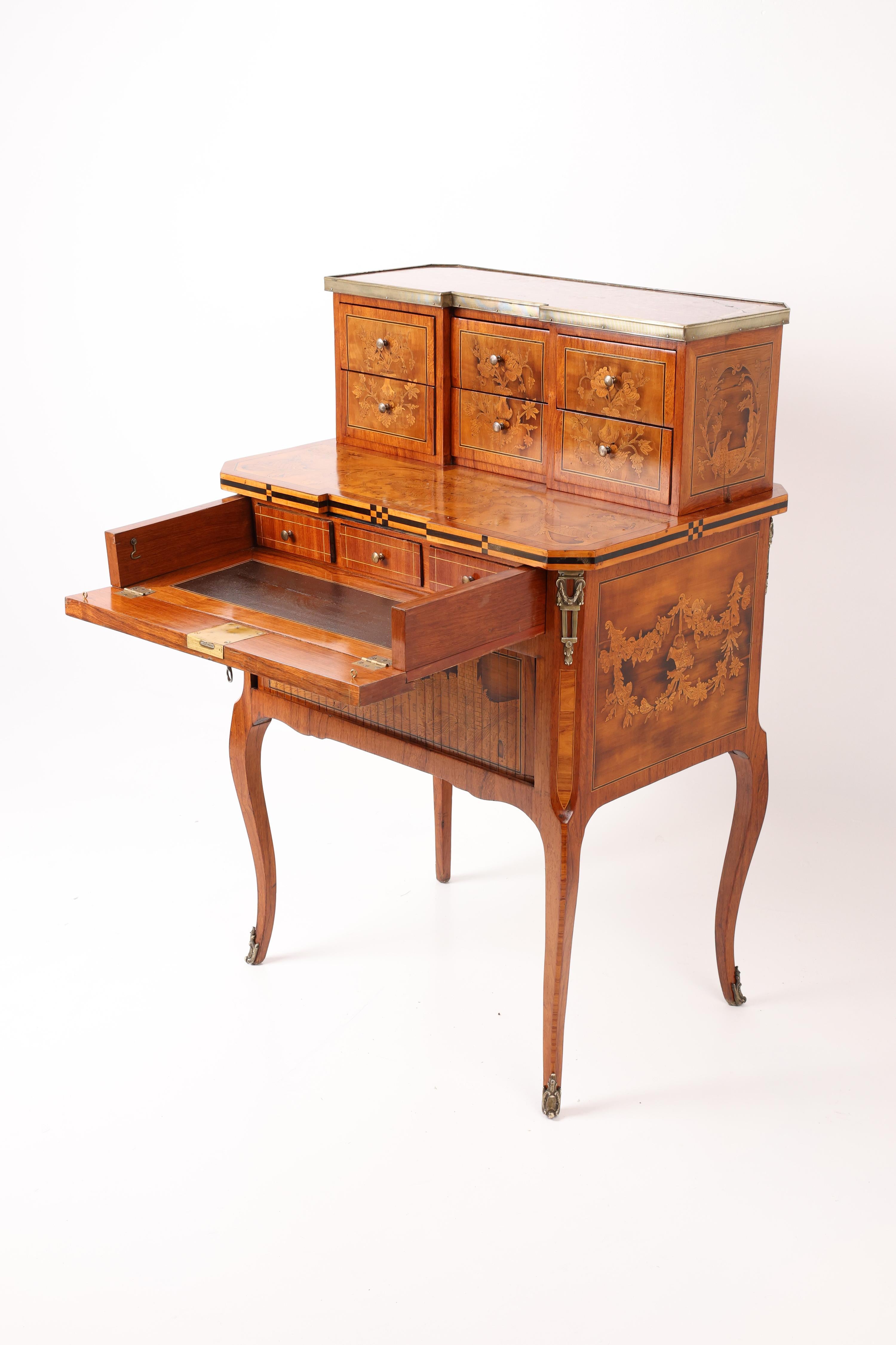 Masterfully Crafted Small Ladies’ Writing Desk

A superbly detailed ladies’ secretary desk, richly decorated with intricate marquetry in walnut, maple, ash, and various other fine woods.

The lower section features an elaborately designed writing