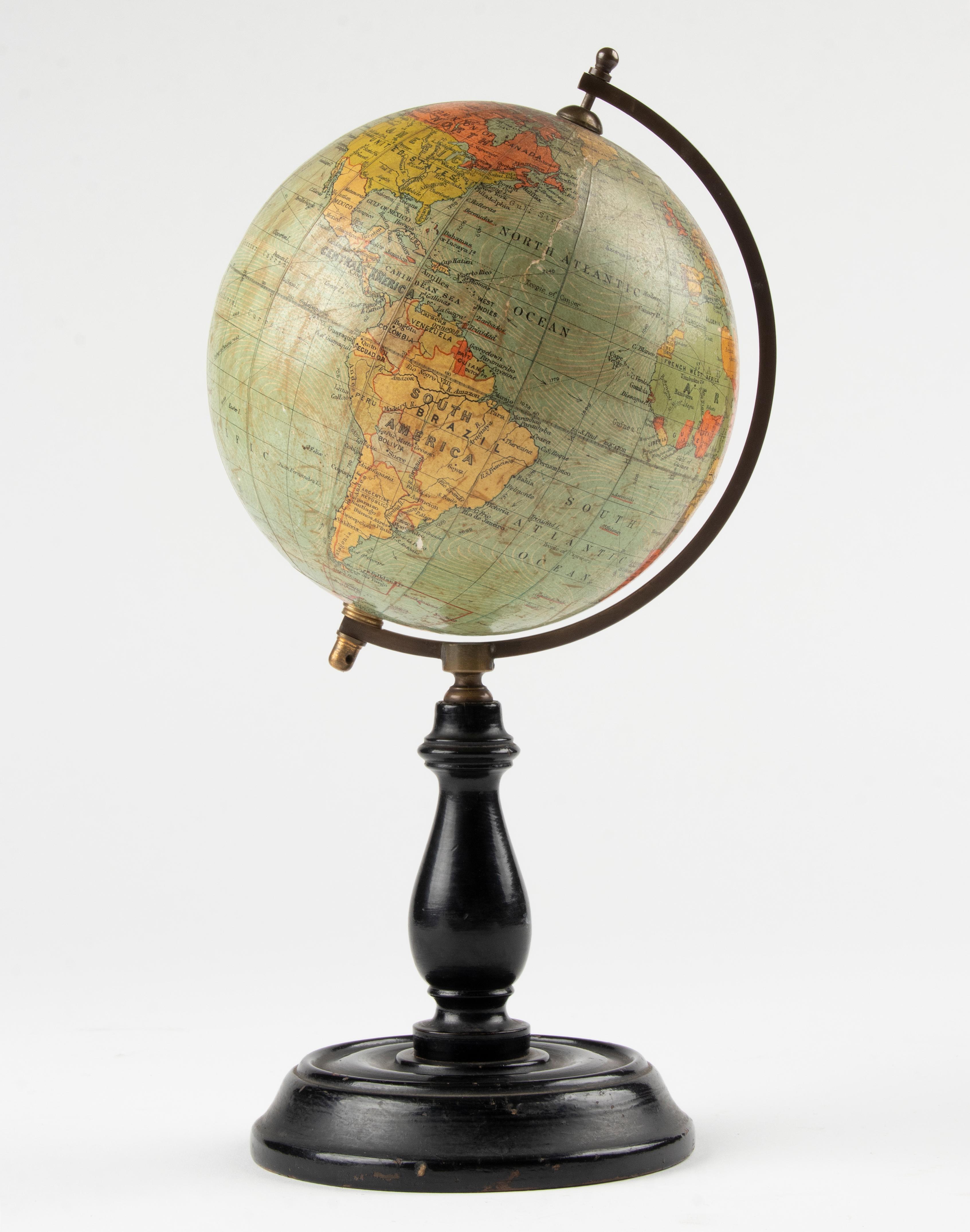 A lovely small size antique French globe. With a wooden base, the globe itself is made of carton with paper. The map is published by Philips Terrestrial from London. Due to its small size, this is a special globe. It is in very nice condition with