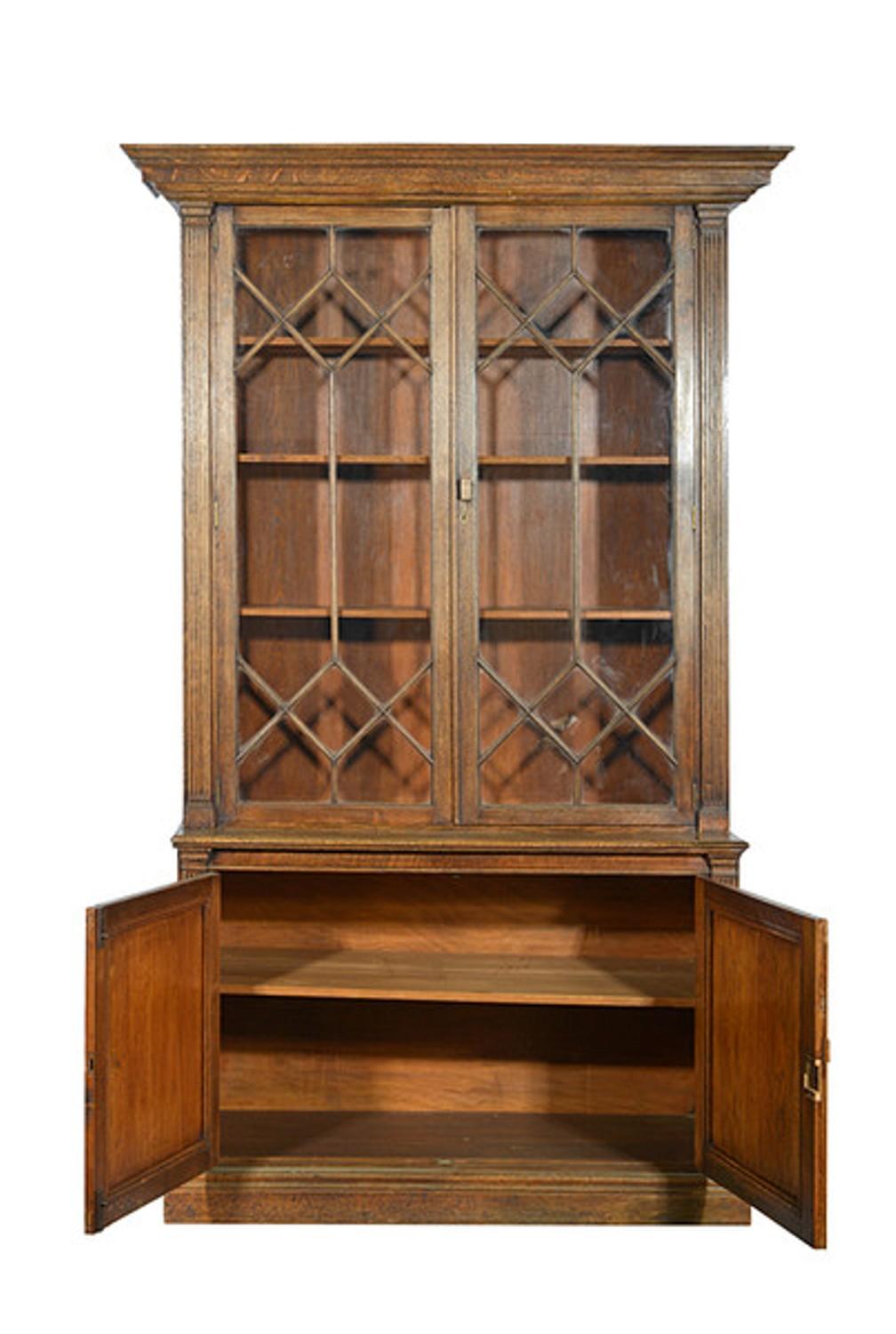 A Late 19th century solid oak bookcase of good proportions and with a clean classic architectural feel.

The top section with a wide angled and stepped pediment sits above a pair of astral glazed doors enclosing three adjustable shelves.

The