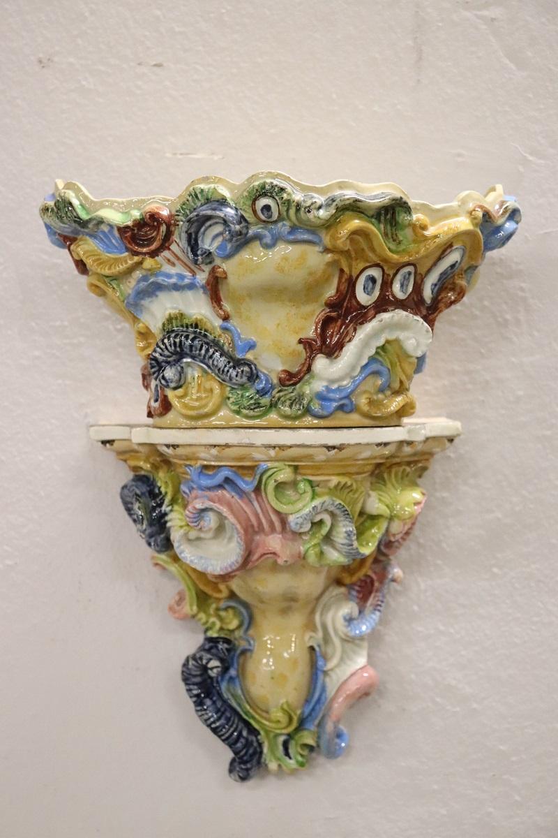 Cette paire d'étagères en majolia avec vase est belle et raffinée. Caractérisé par une riche décoration et des couleurs vives de goût baroque typique de la production sicilienne dans le sud de l'Italie. En bon état, a quelques signes d'usure, s'il