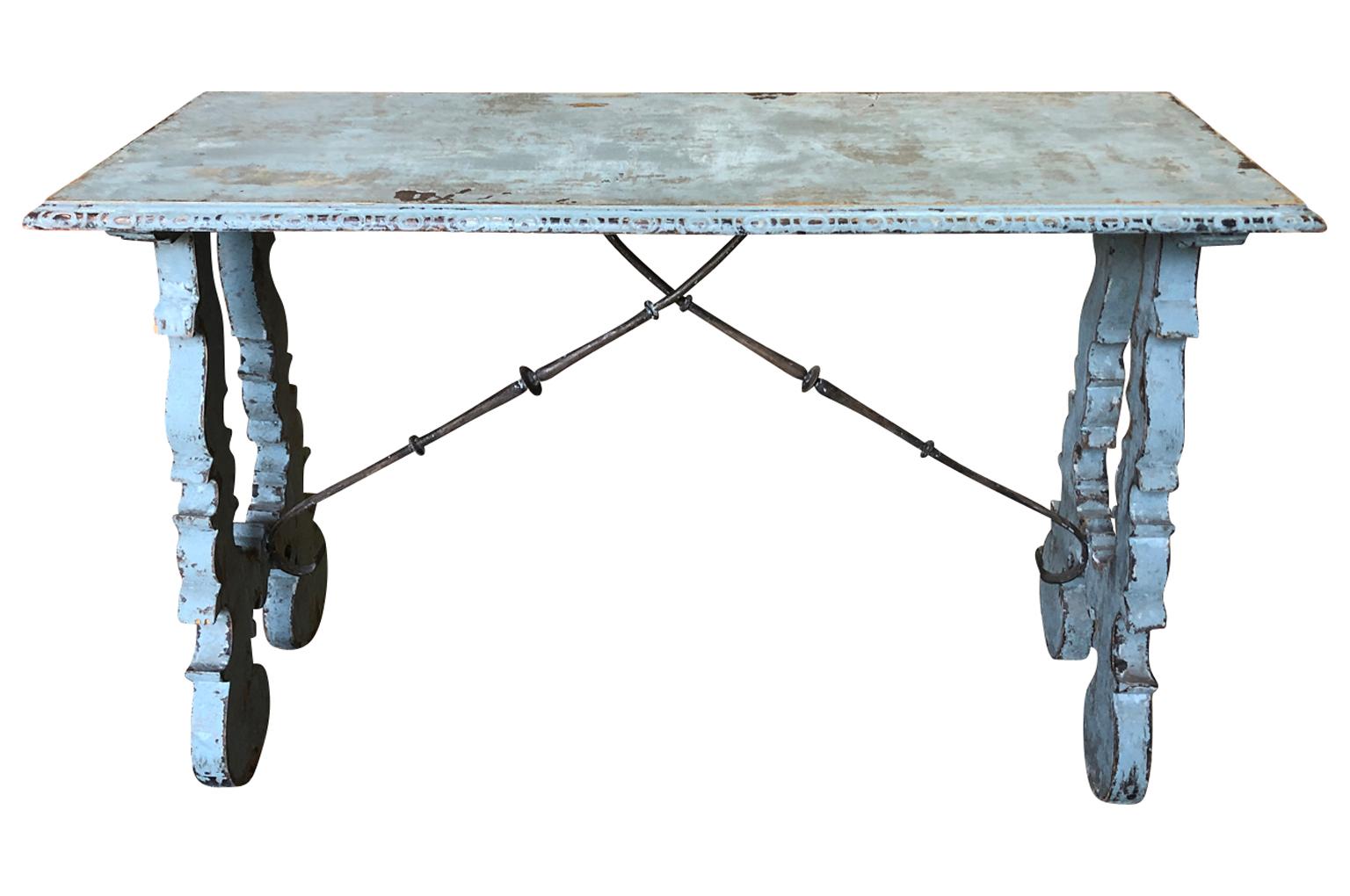 A very charming later 19th century console table from the Catalan region of Spain. Handsomely constructed from painted wood with classical lyre shaped legs and iron stretchers. A wonderful accent piece.