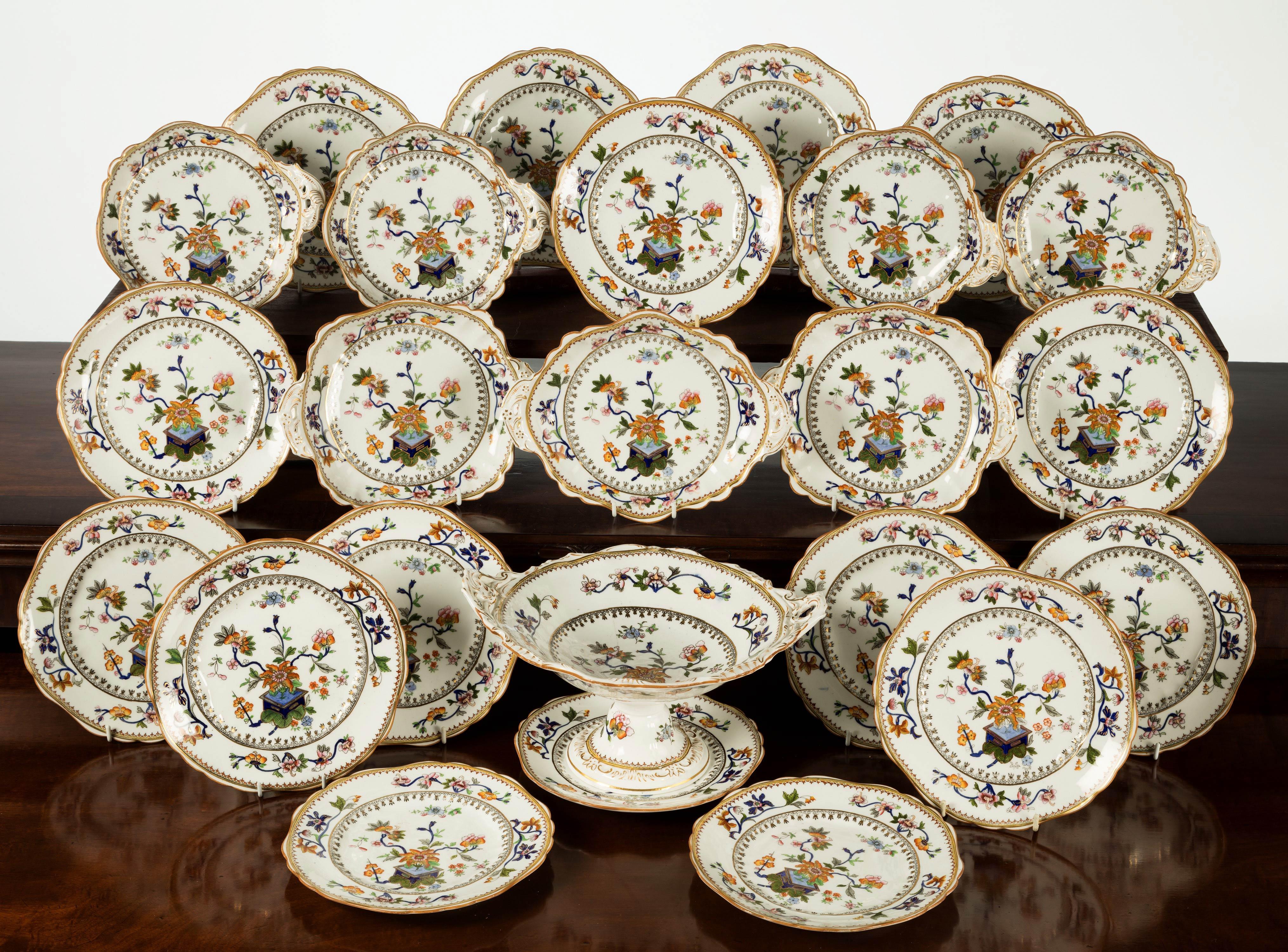 A most attractive late 19th century Staffordshire, porcelain dessert service. Still in crisp condition with well shaped dishes and a compote. Comprising of 24 pieces:

16 plates 9 inches
4 scallop plates - 9 x 8 inches
2 entree dishes - 10 x 8